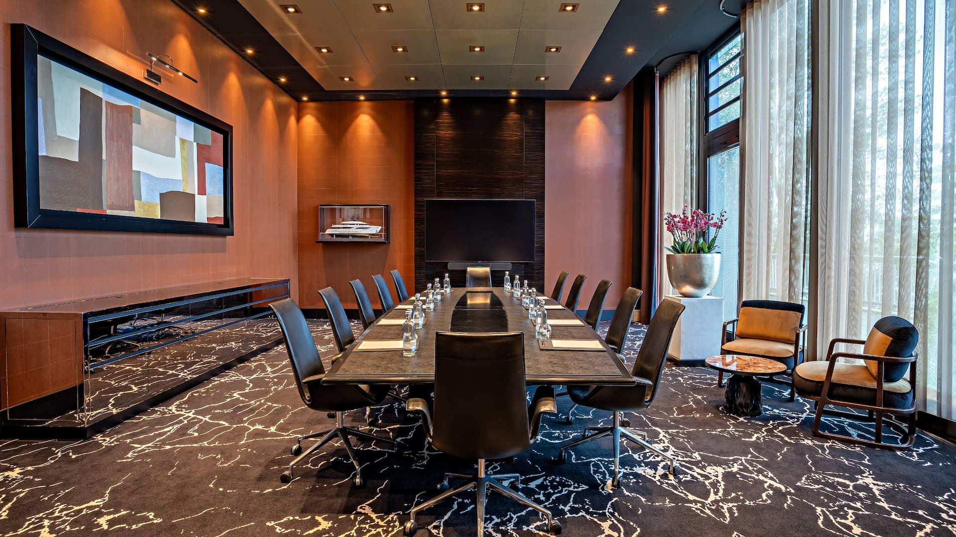 Executive Room at the Hyatt Regency Dusseldorf, with long table and office chairs, large TV, beautiful picture and floor to c