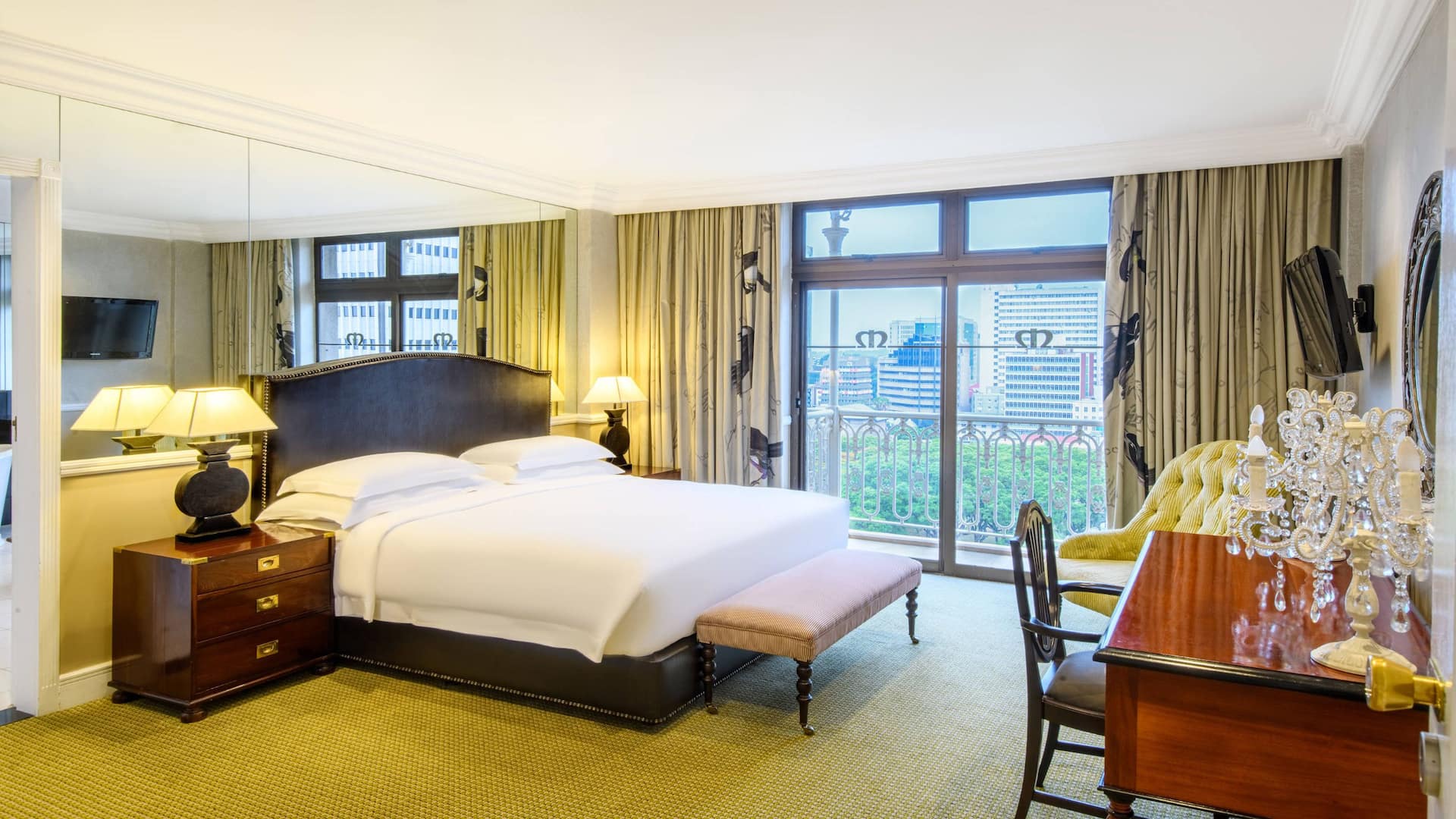 Imperial suite at Hyatt Regency Harare The Meikles in Harare, featuring a comfortable bed and a spacious desk.