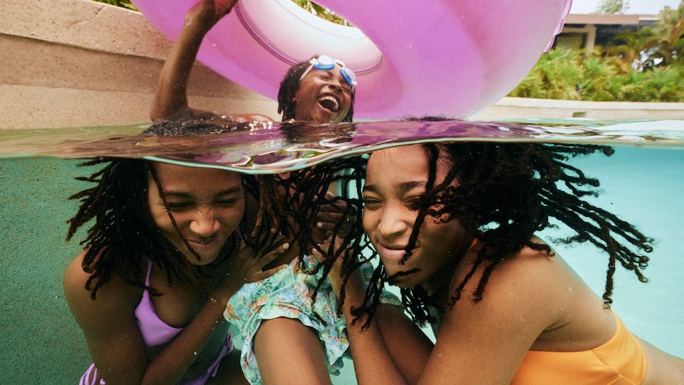 Family playing in pool