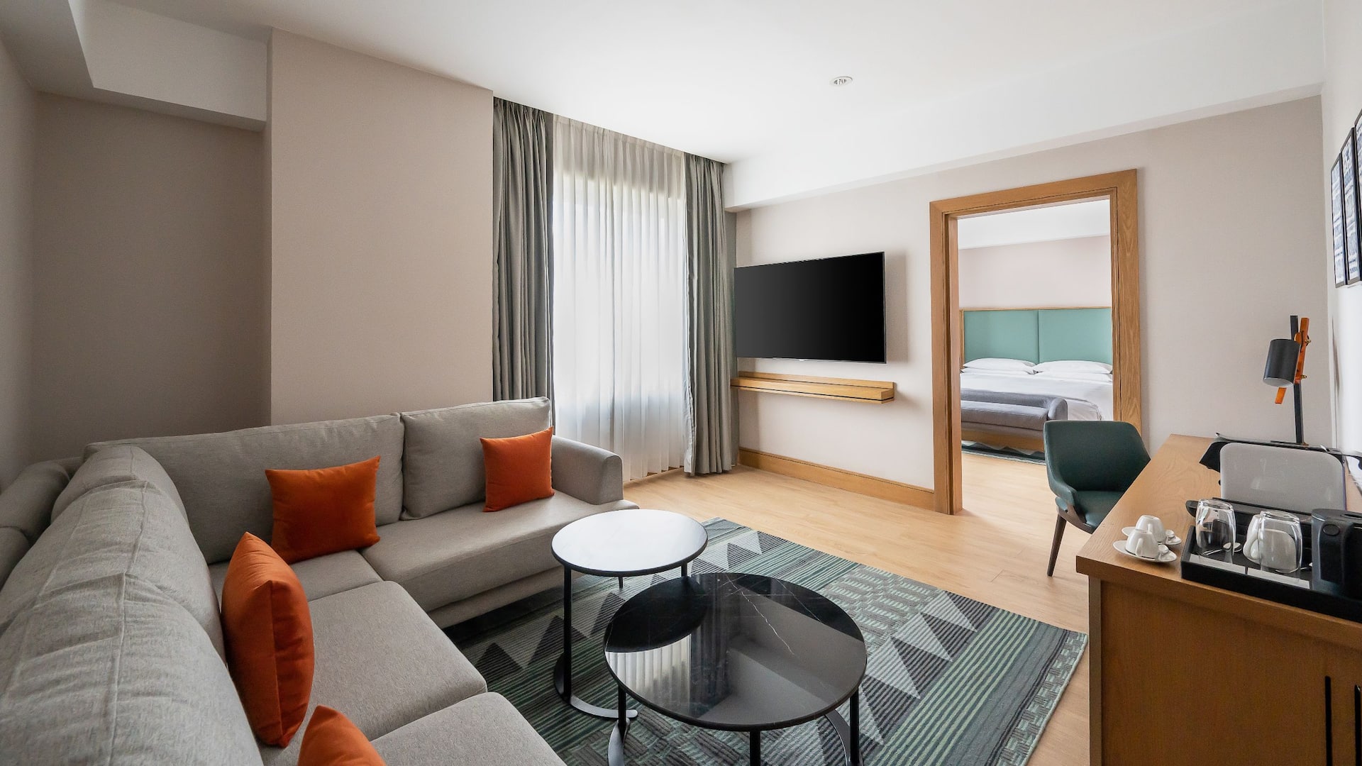 Contemporary suite with a stylish living area, vibrant cushions and a separate bedroom area for added privacy and comfort.