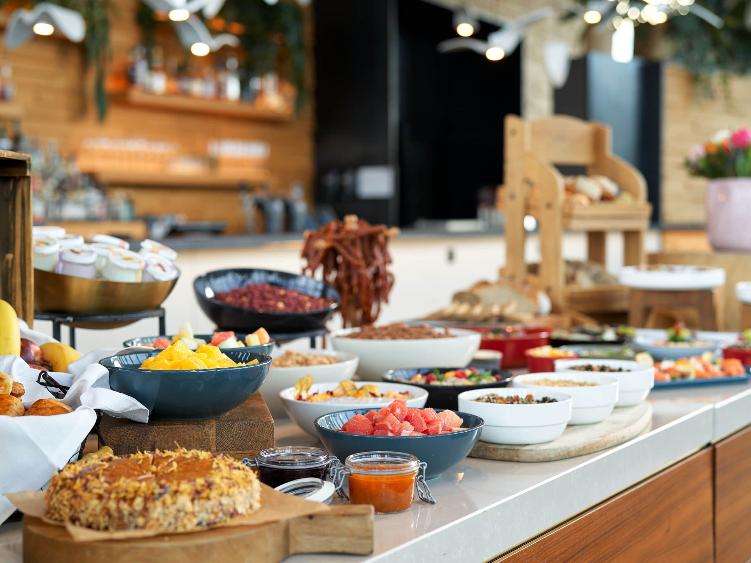 A lavish breakfast buffet with fresh fruit and a selection of delicious cakes