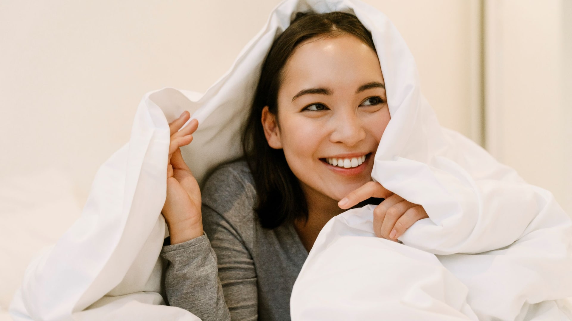 Hyatt Hotels Stock Woman Bed Under Covers Smiling