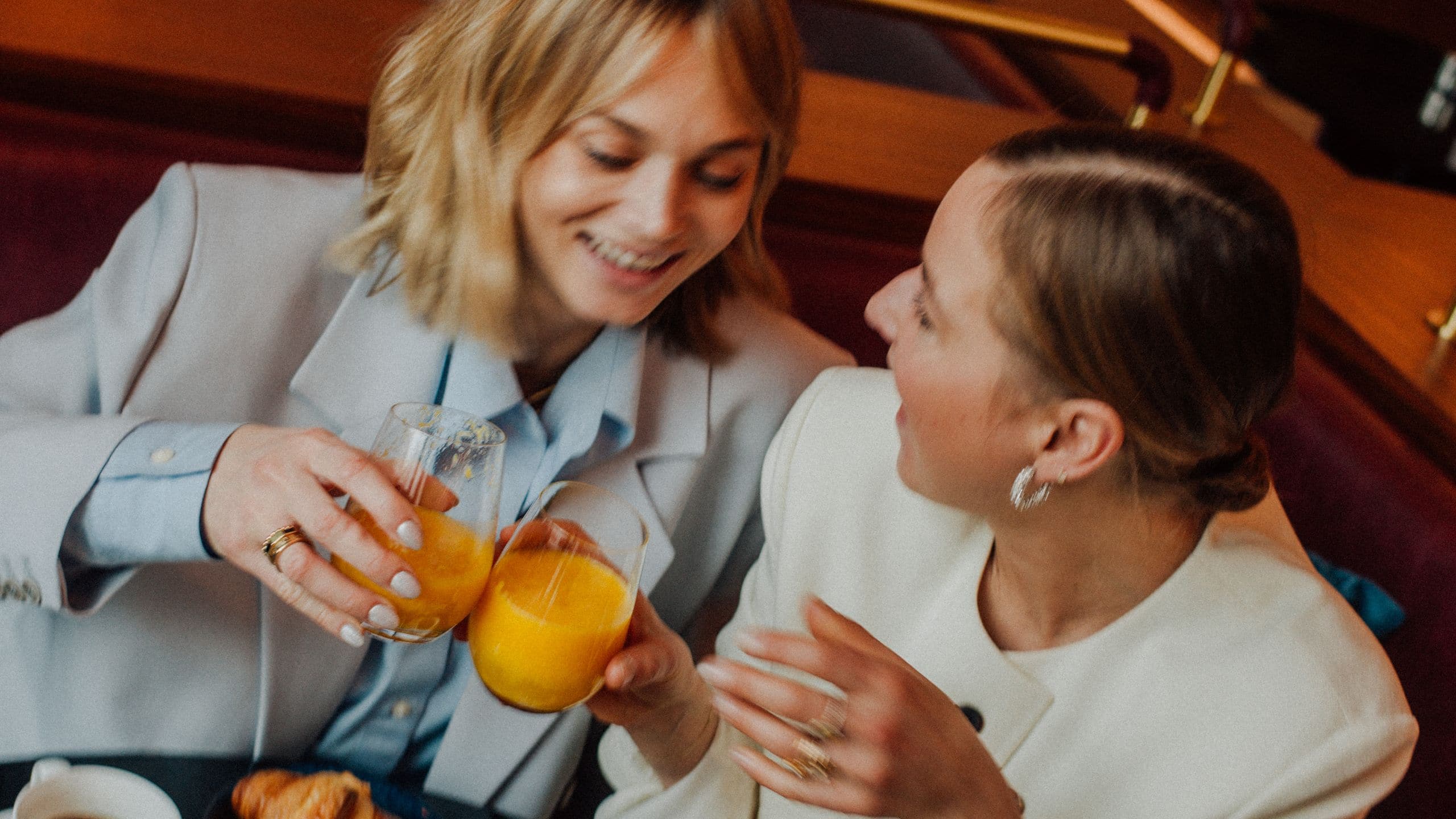 Two women enjoying breakfast at The Lonely Broccoli restaurant, featuring modern decor and cozy tables