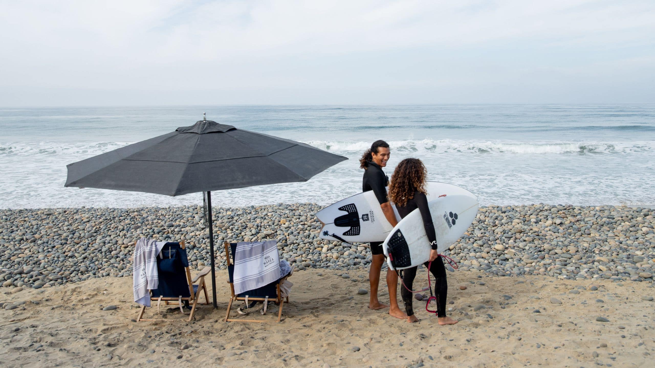 Alila Marea Beach Resort Encinitas Couple With Surfboards And Beach Set Up