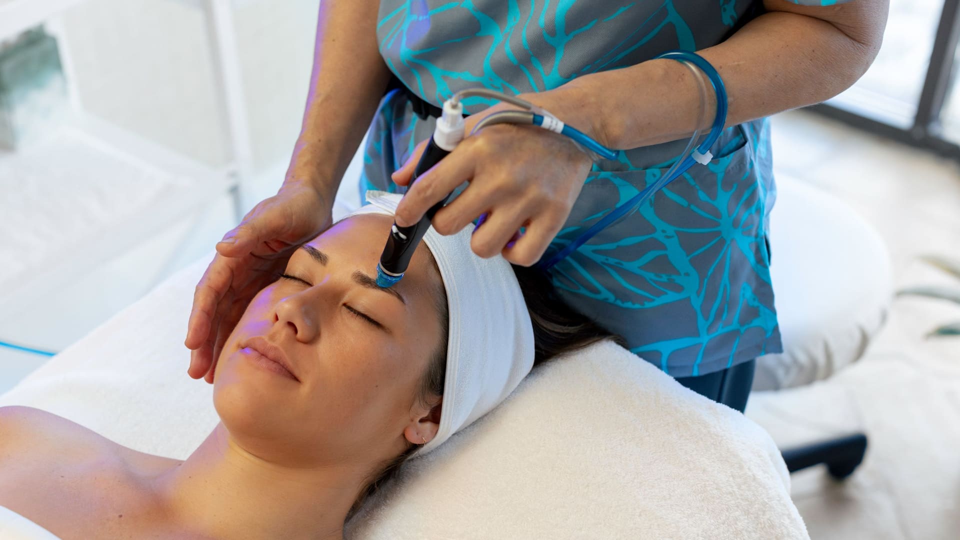 Hyatt Regency Waikiki Beach Resort and Spa Female Enjoying Hydrafacial Treatment From Side Angle
