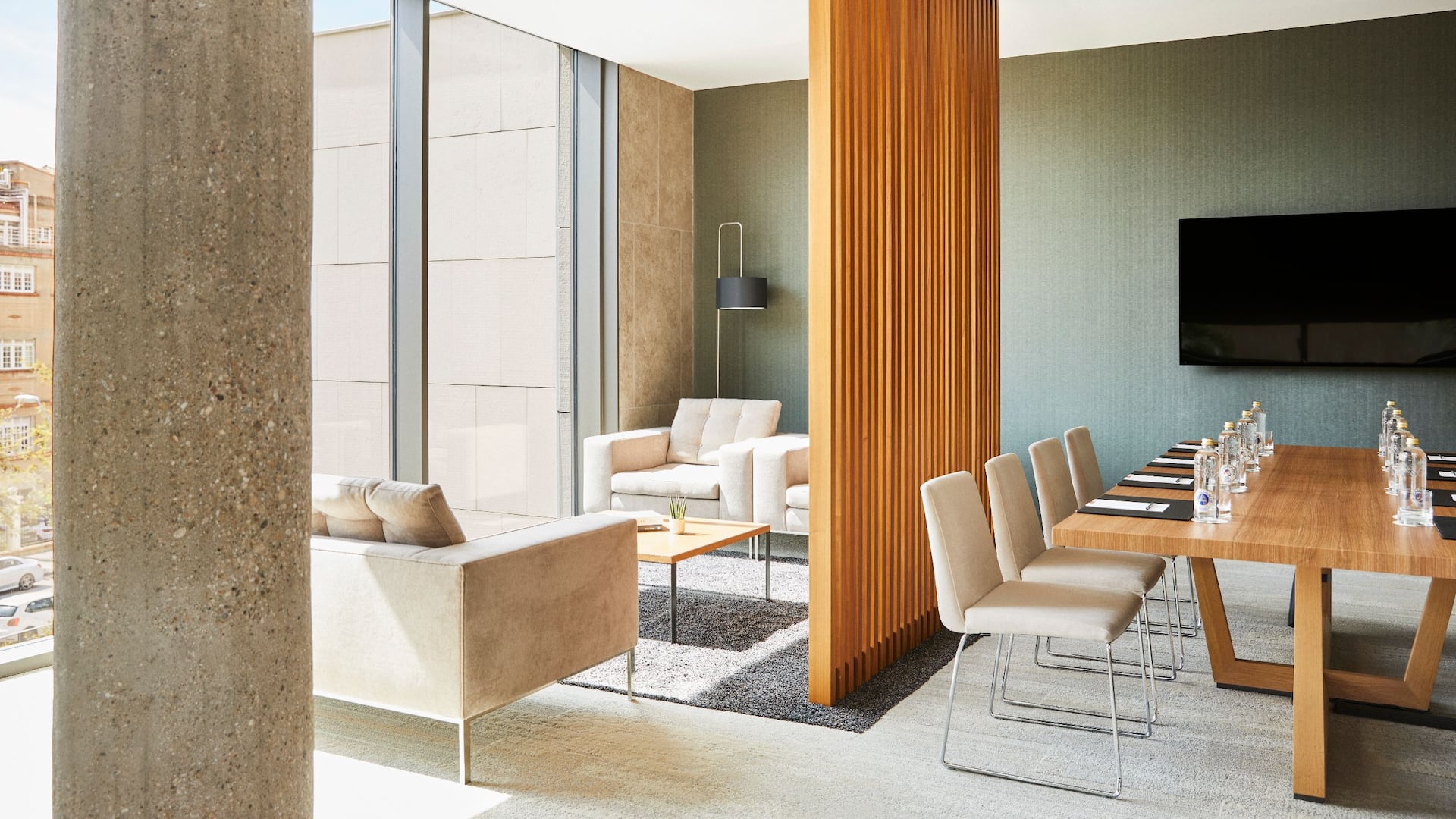 1 of 8 Elevated meeting room in Barcelona at Grand Hyatt Barcelona, featuring a boardroom setup complemented by a stylish sofa lounge area, bathed in natural light and offering a refined atmosphere.