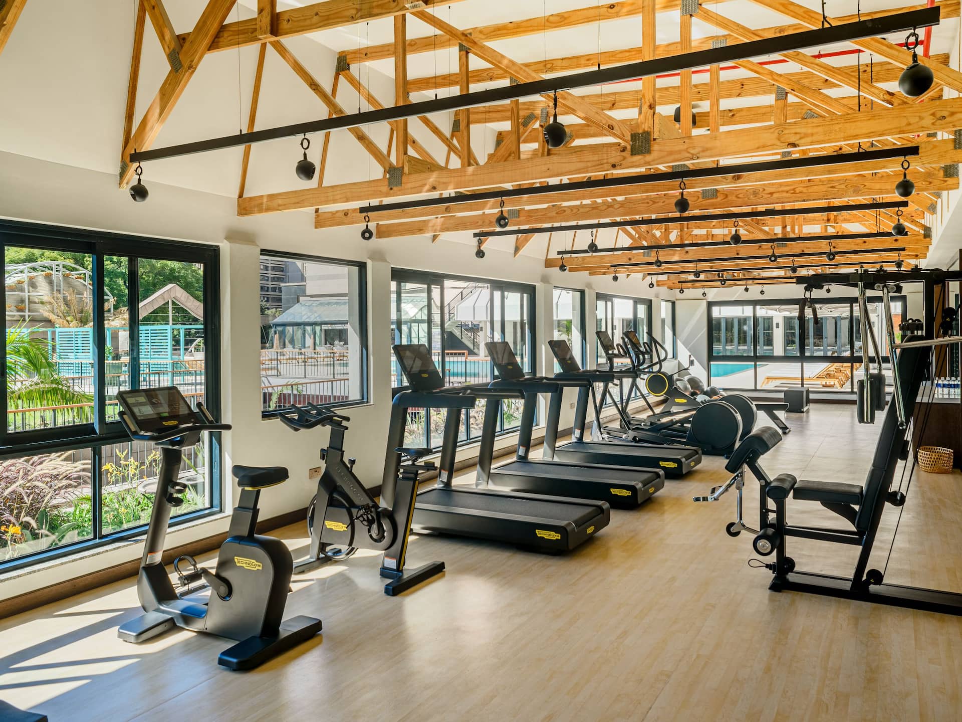 A luxury hotel gym at Hyatt Regency Harare The Meikles, featuring treadmills and a large window offering stunning views.