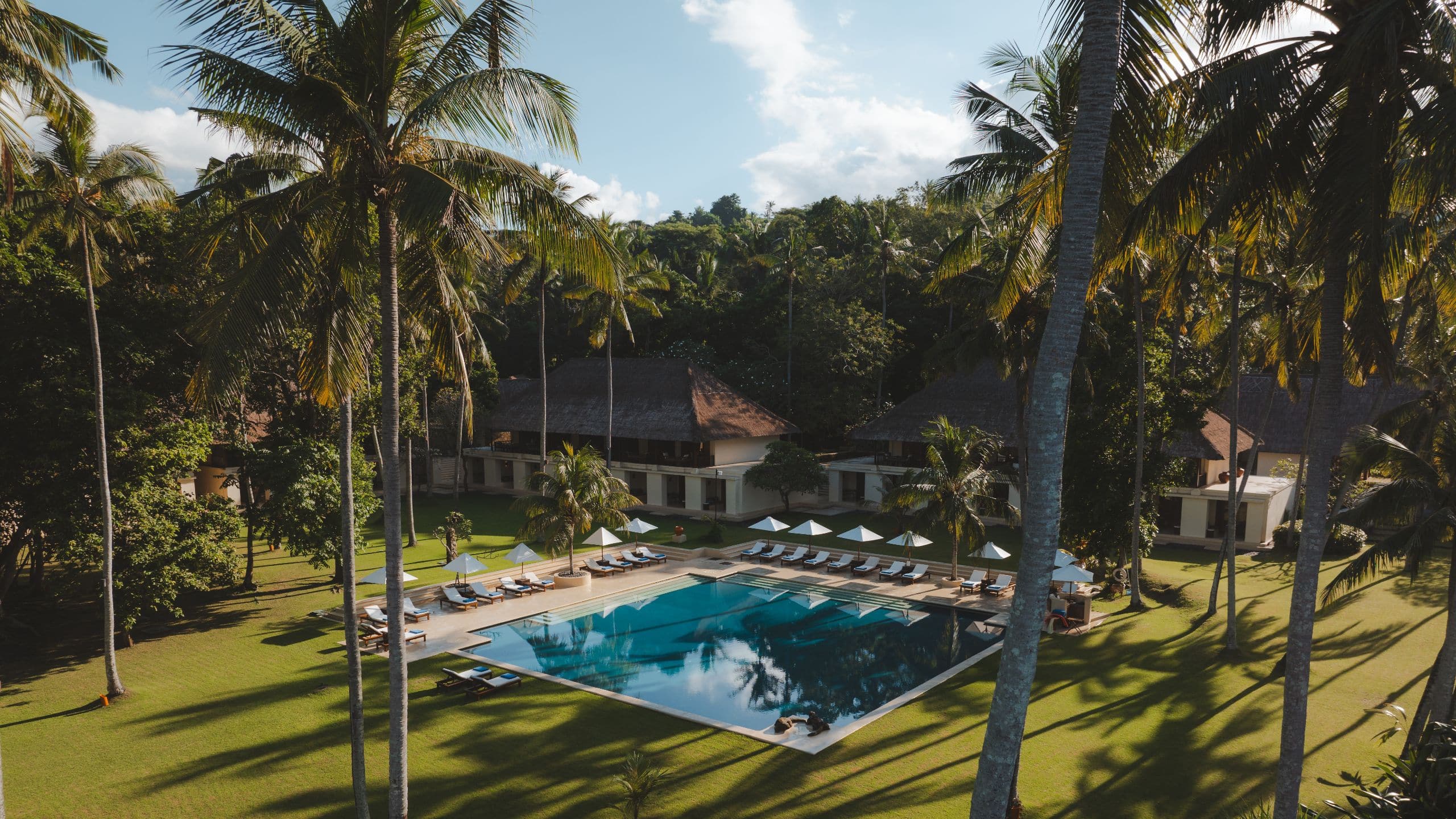 Alila Manggis Main Pool Coconut Groove Sun Loungers Coconuts