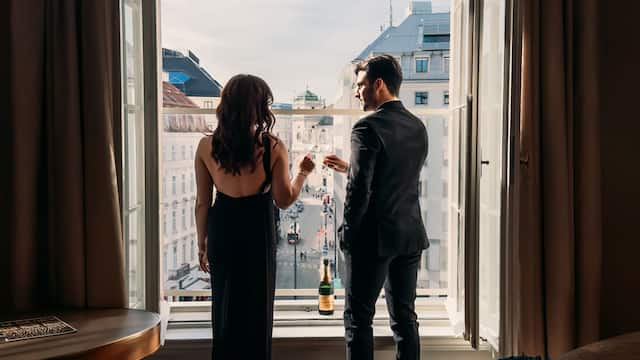 A couple is savoring a romantic getaway in a suite at the luxurious Park Hyatt Vienna hotel.