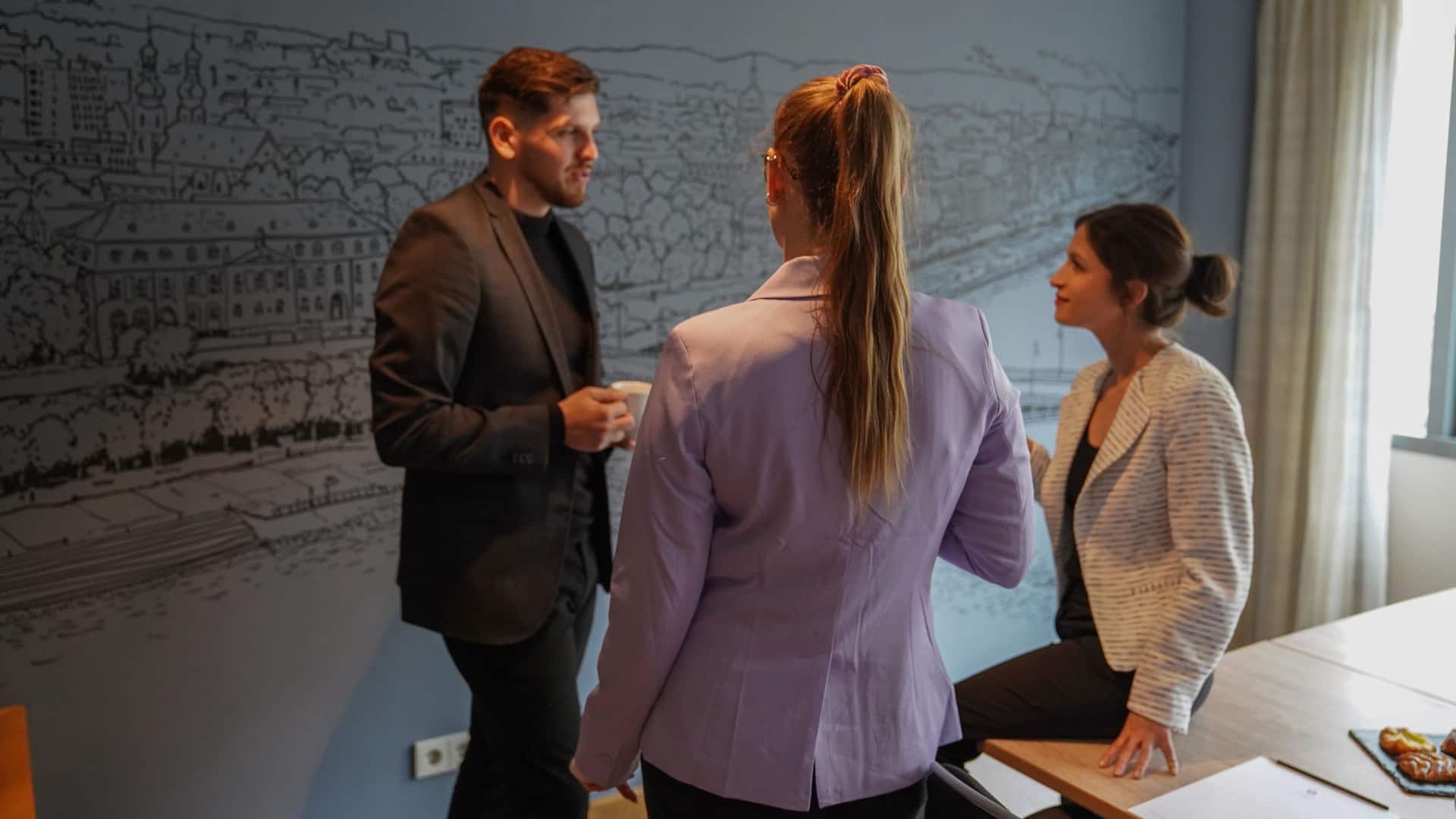 Business people chatting in boardroom of Hyatt Regency Mainz