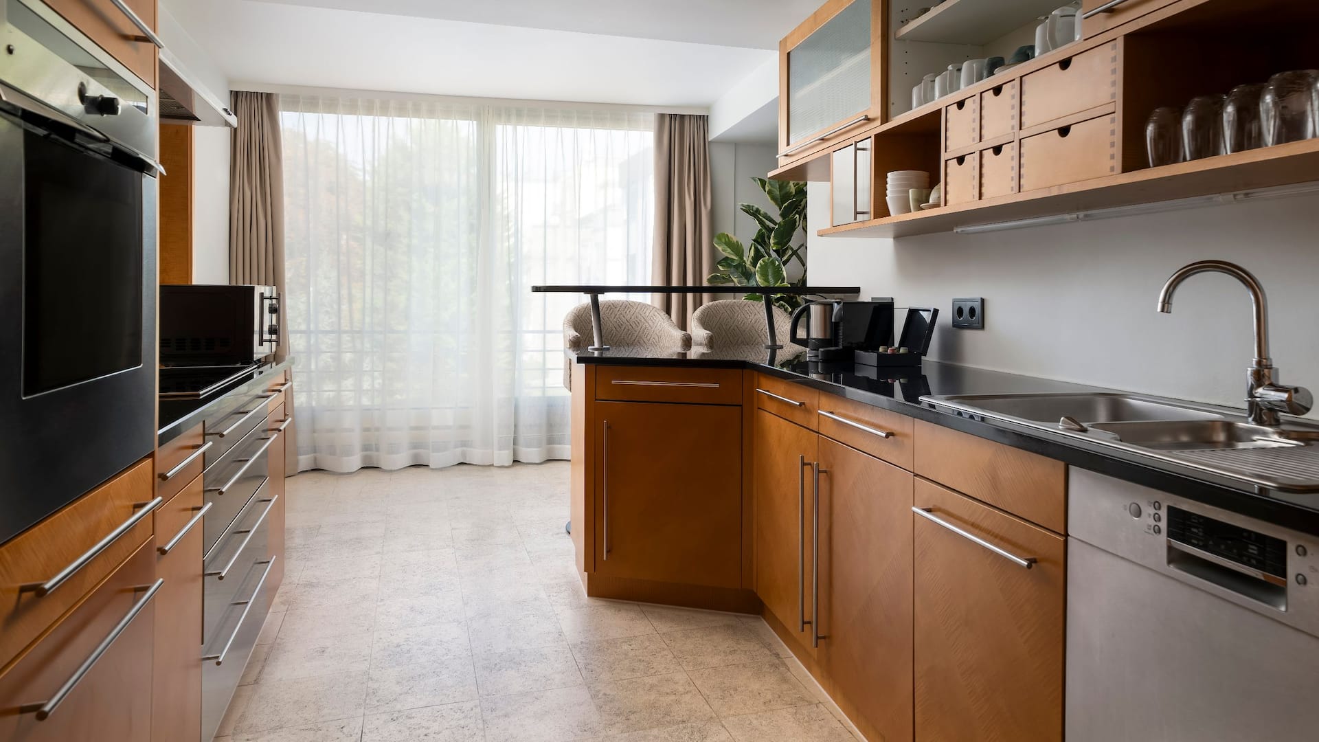 Fully equipped kitchen with wood paneling in Hyatt Regency Mainz apartment