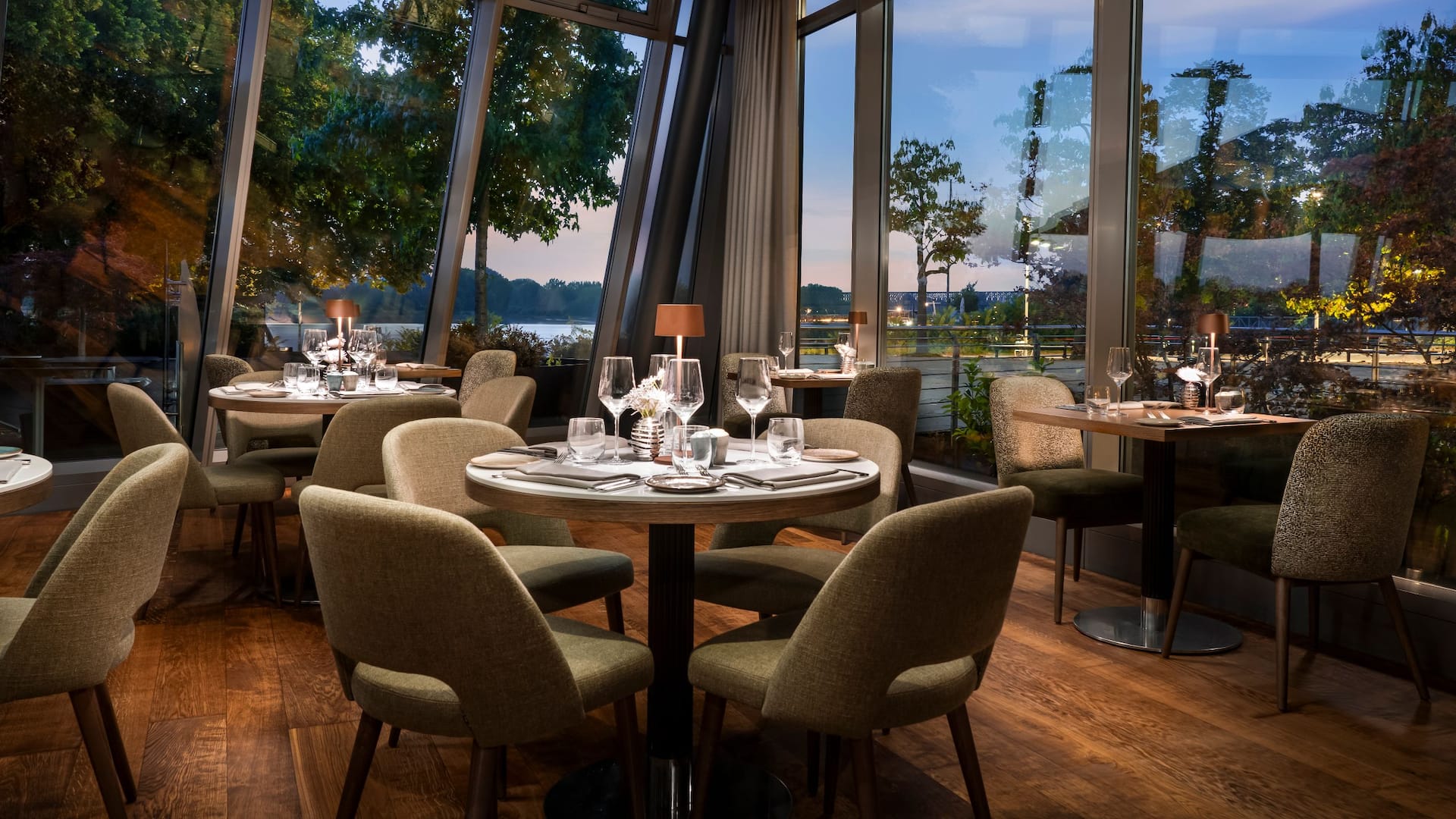 Bellpepper Restaurant seating area in the evening with views of the Rhine promenade and river
