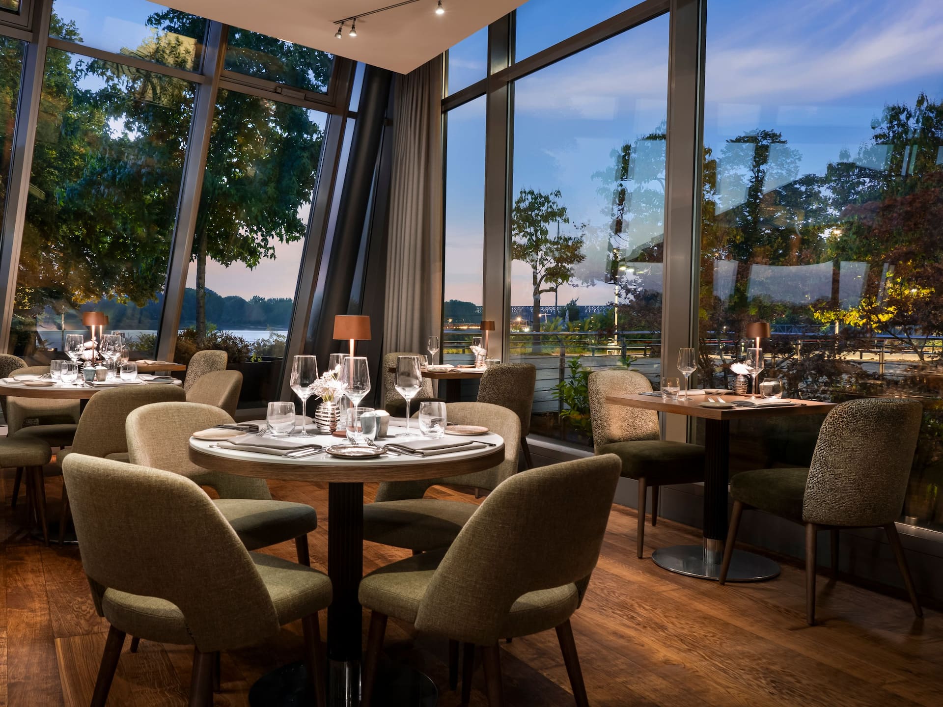 Bellpepper Restaurant seating area in the evening with views of the Rhine promenade and river