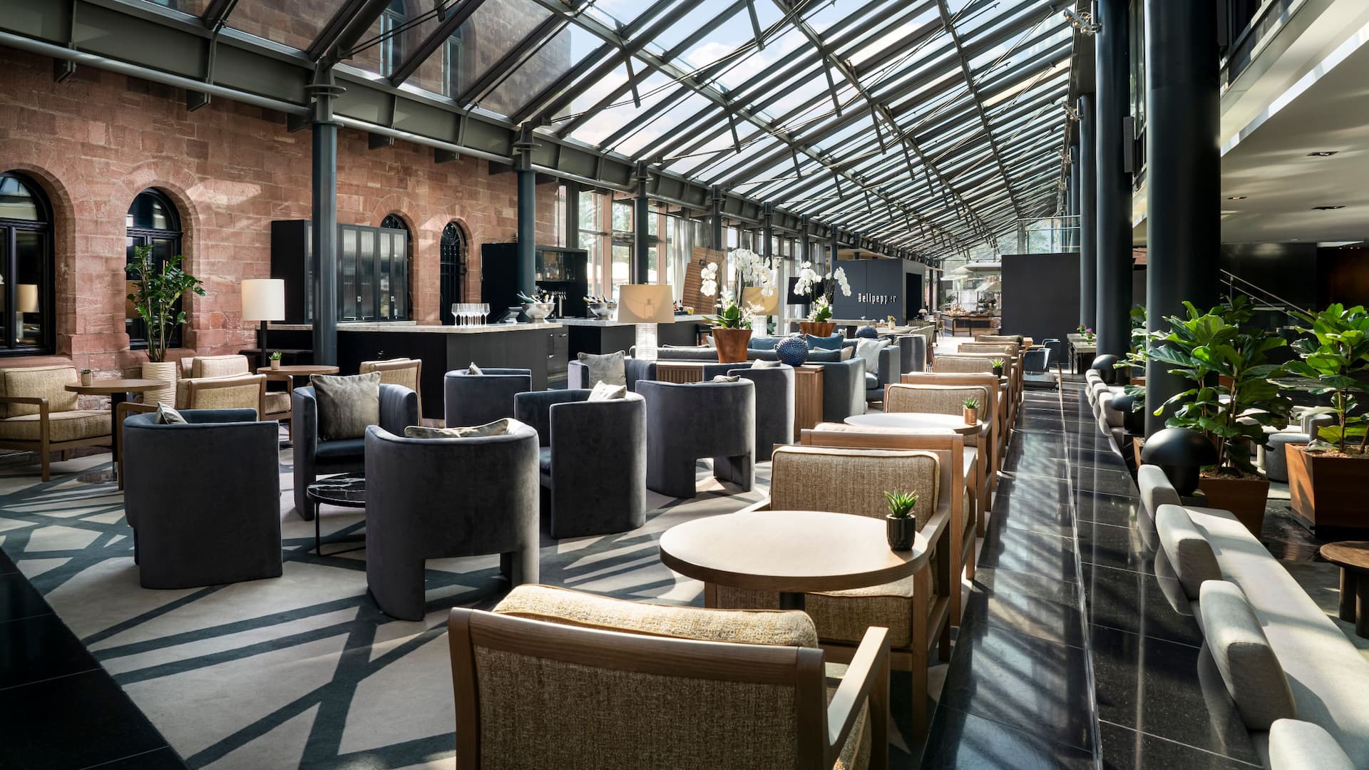 Inviting seating area of the M Lounge with glass roof and between historic Fort Malakoff and lobby of Hyatt Regency Mainz