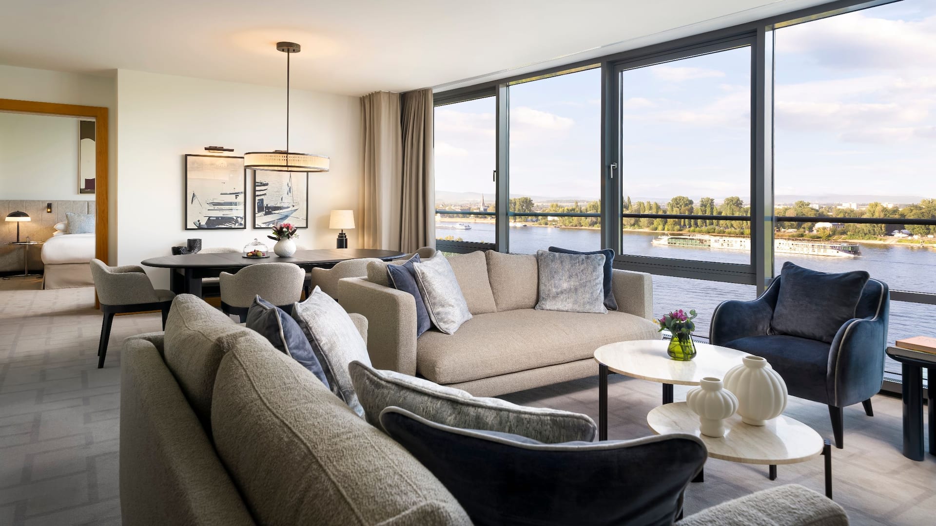 Stylish dining area in suite of Hyatt Regency Mainz with views of the Rhine river