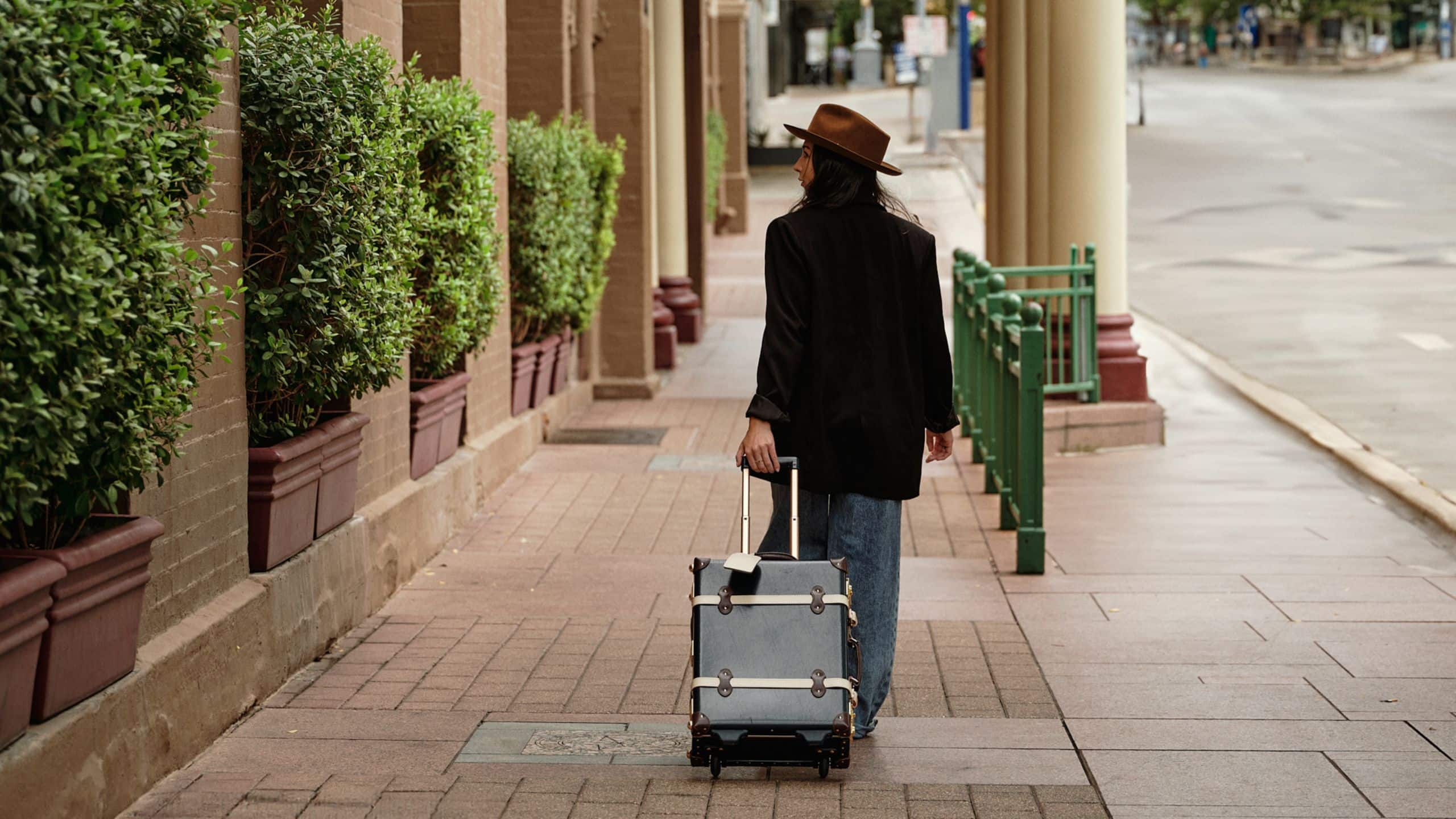 The Driskill Woman With Luggage Outside