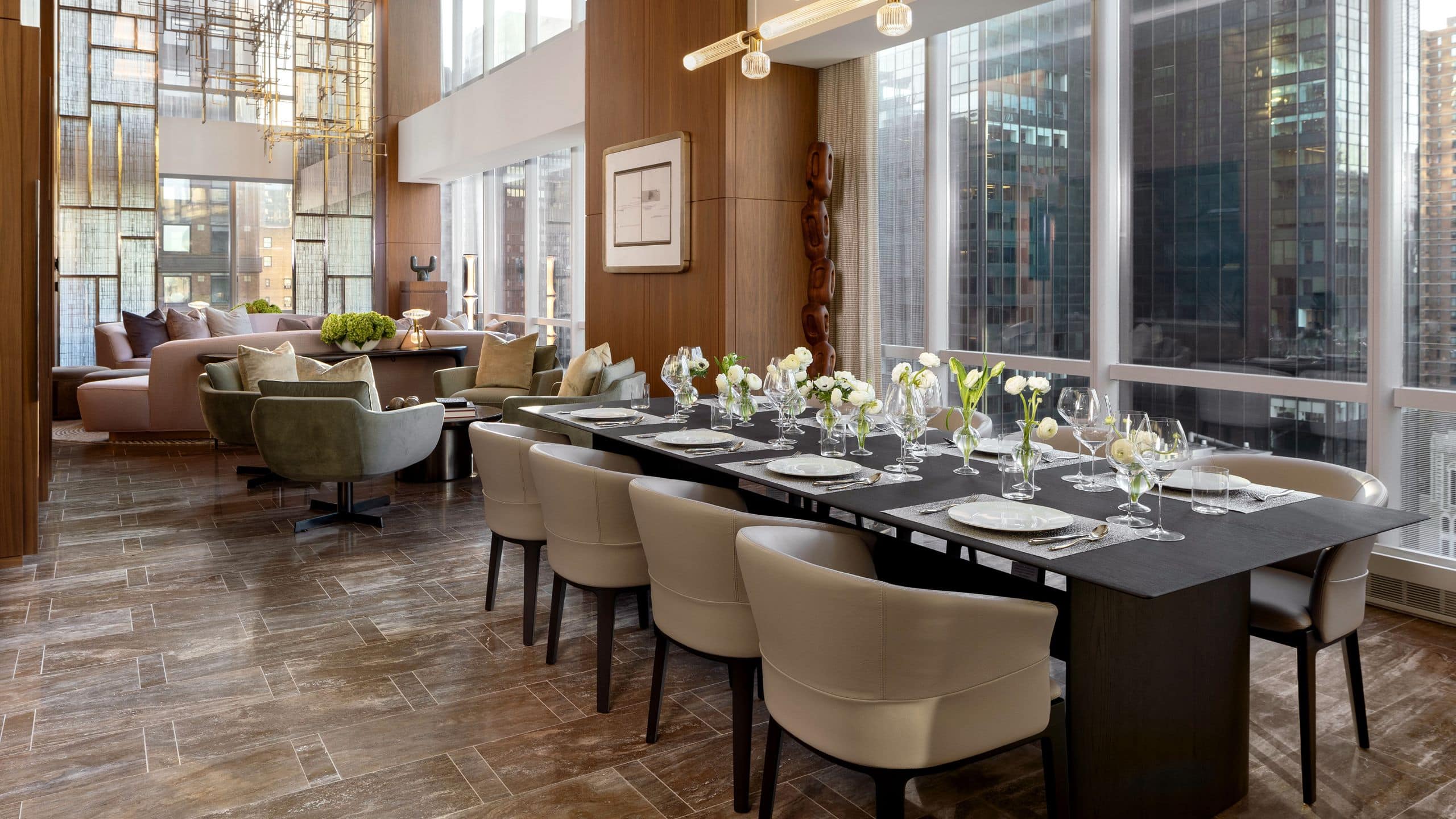 Expansive in suite dining and living room area with crystal light fixtures and 18 foot floor to ceiling windows