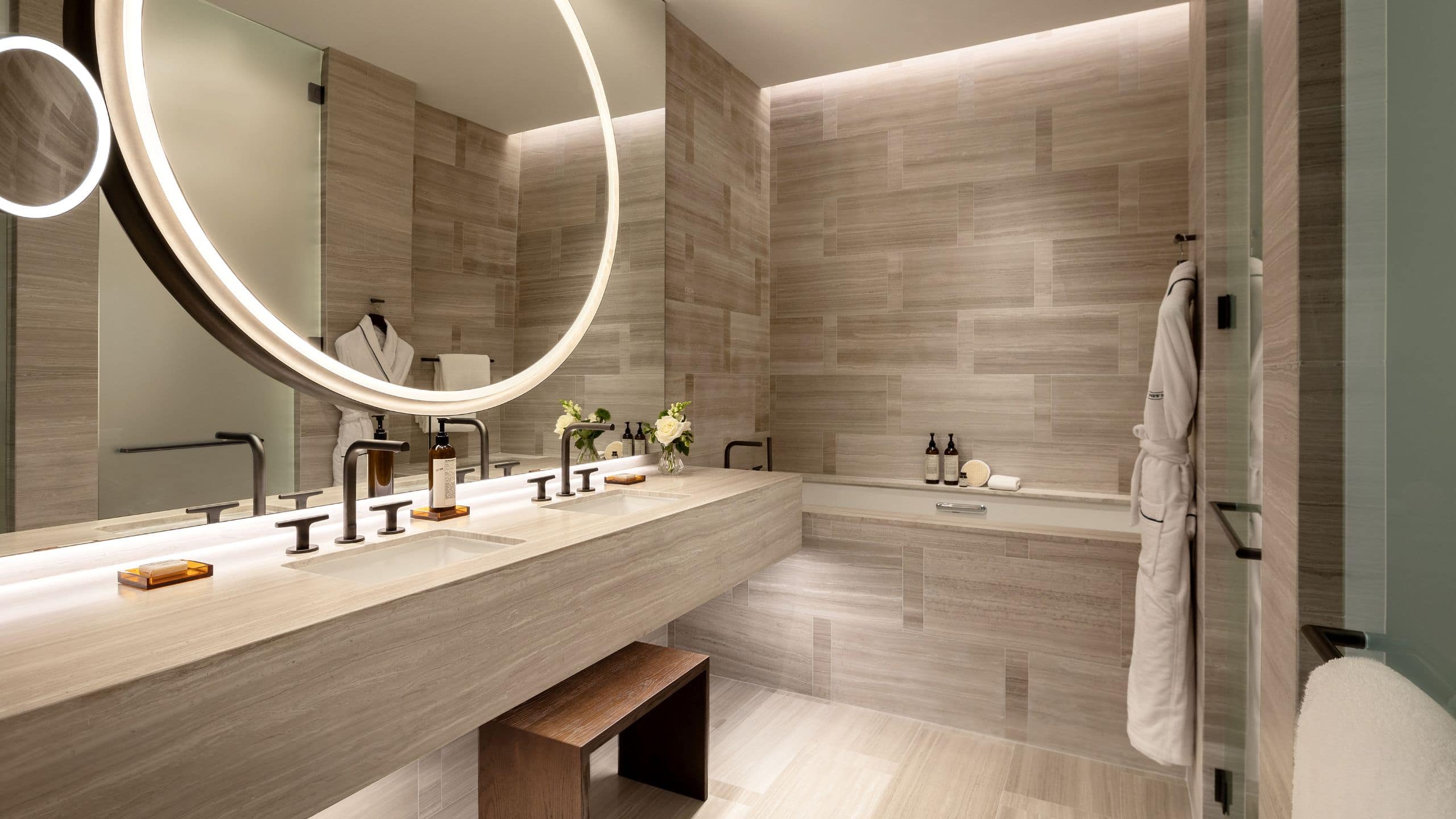 5 из 7 Floor to ceiling marble bathroom with large circular backlit mirrors, double sink and bathtub