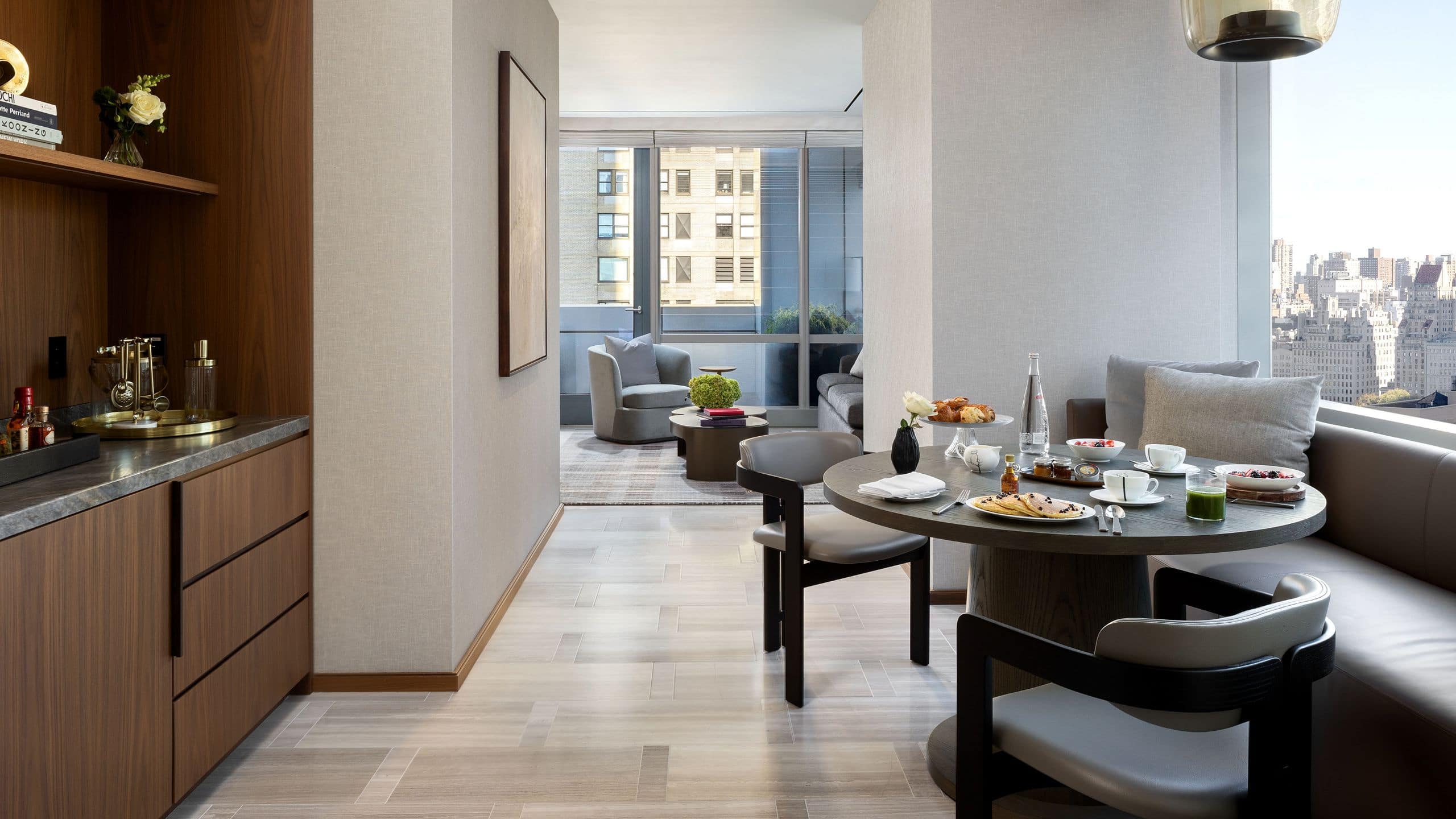 7 из 7 Spacious suite living area with dining nook seating, table, with large windows and doors that open to a balcony