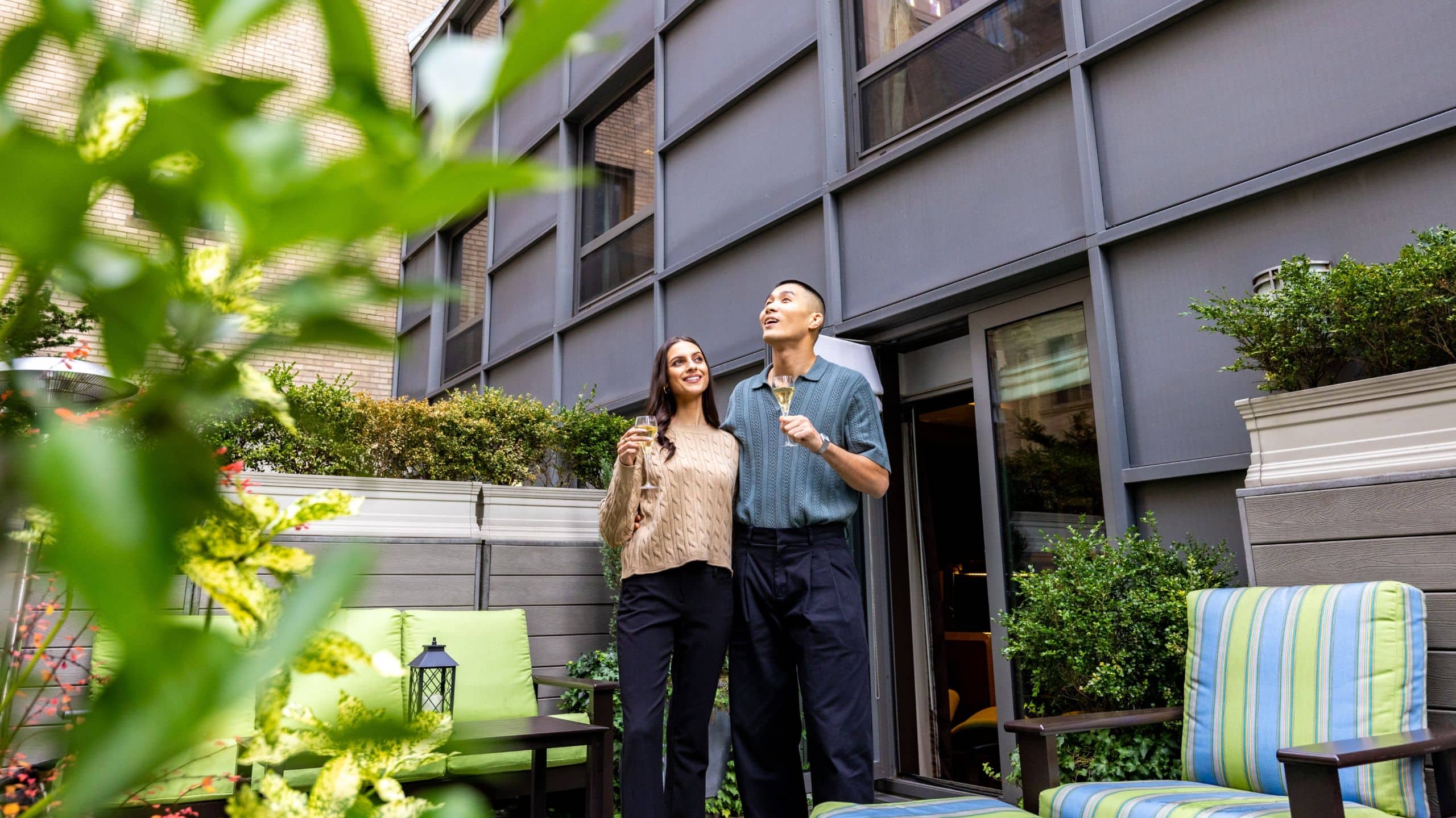 3 of 7 The Chatwal Couple Enjoying Cocktail Outdoor Terrace
