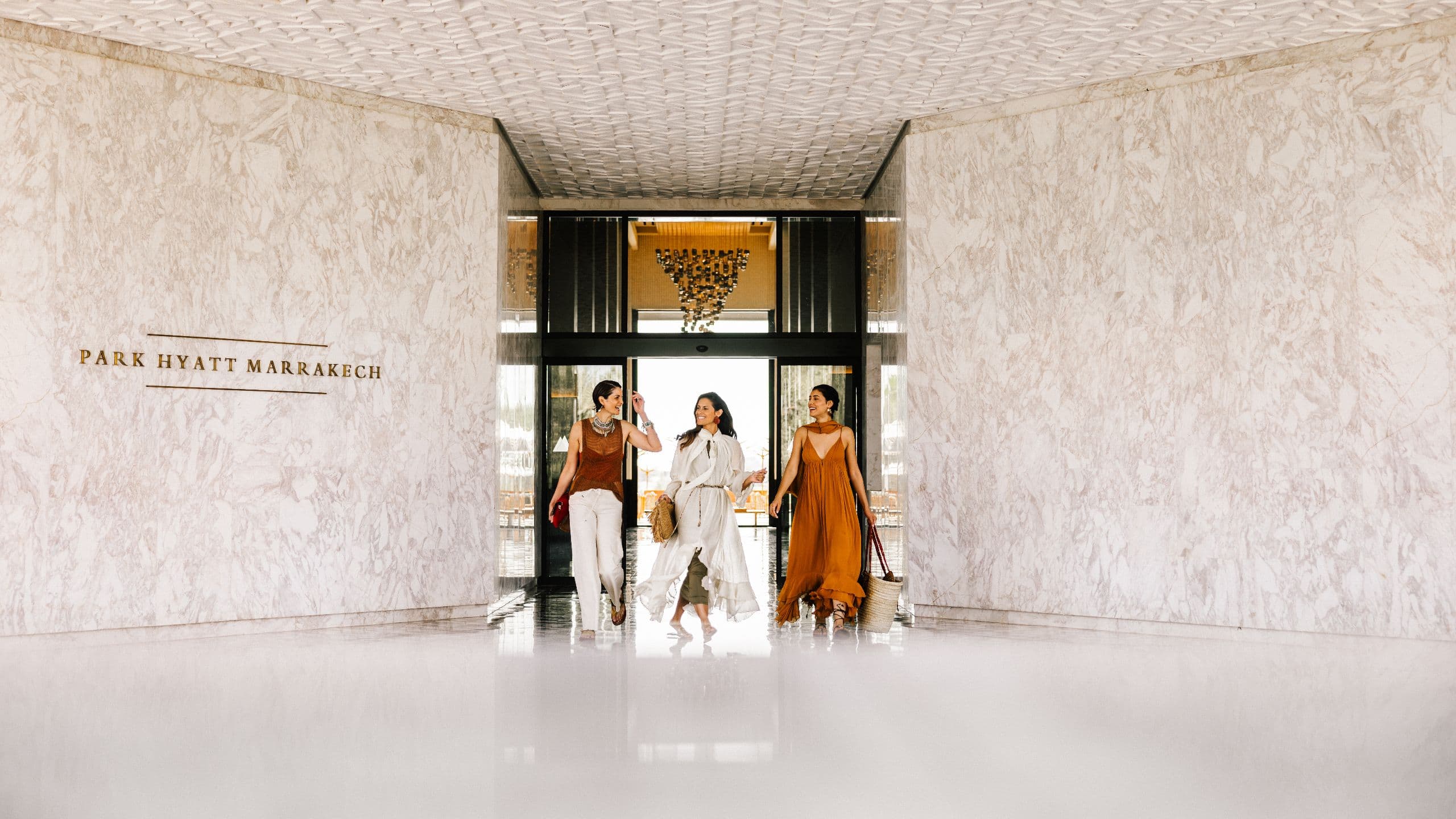 Park Hyatt Marrakech Entrance Three Woman Smiling Walking White Marble