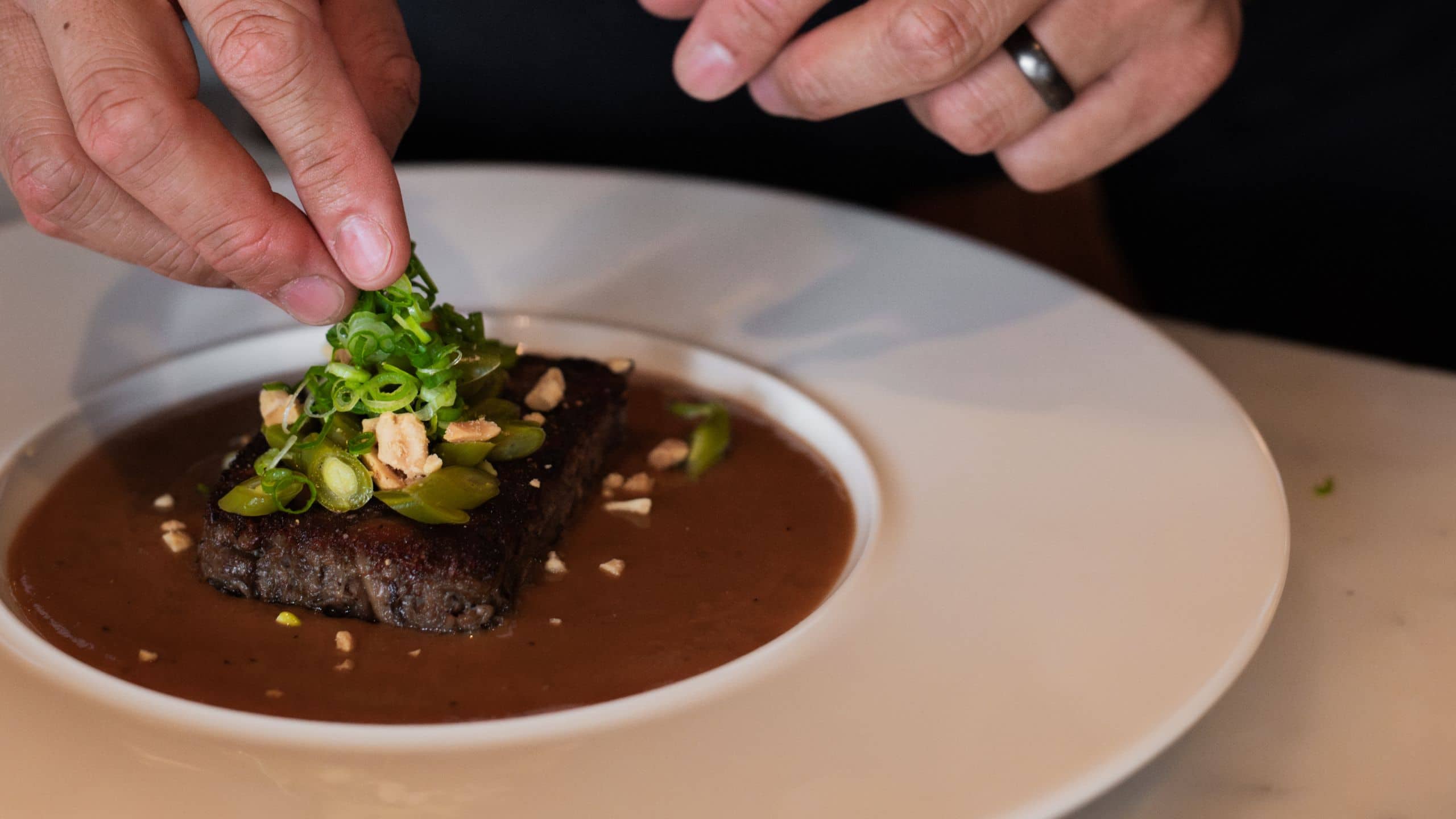 Park Hyatt Chicago Chef Plating Oxtail With Garnish