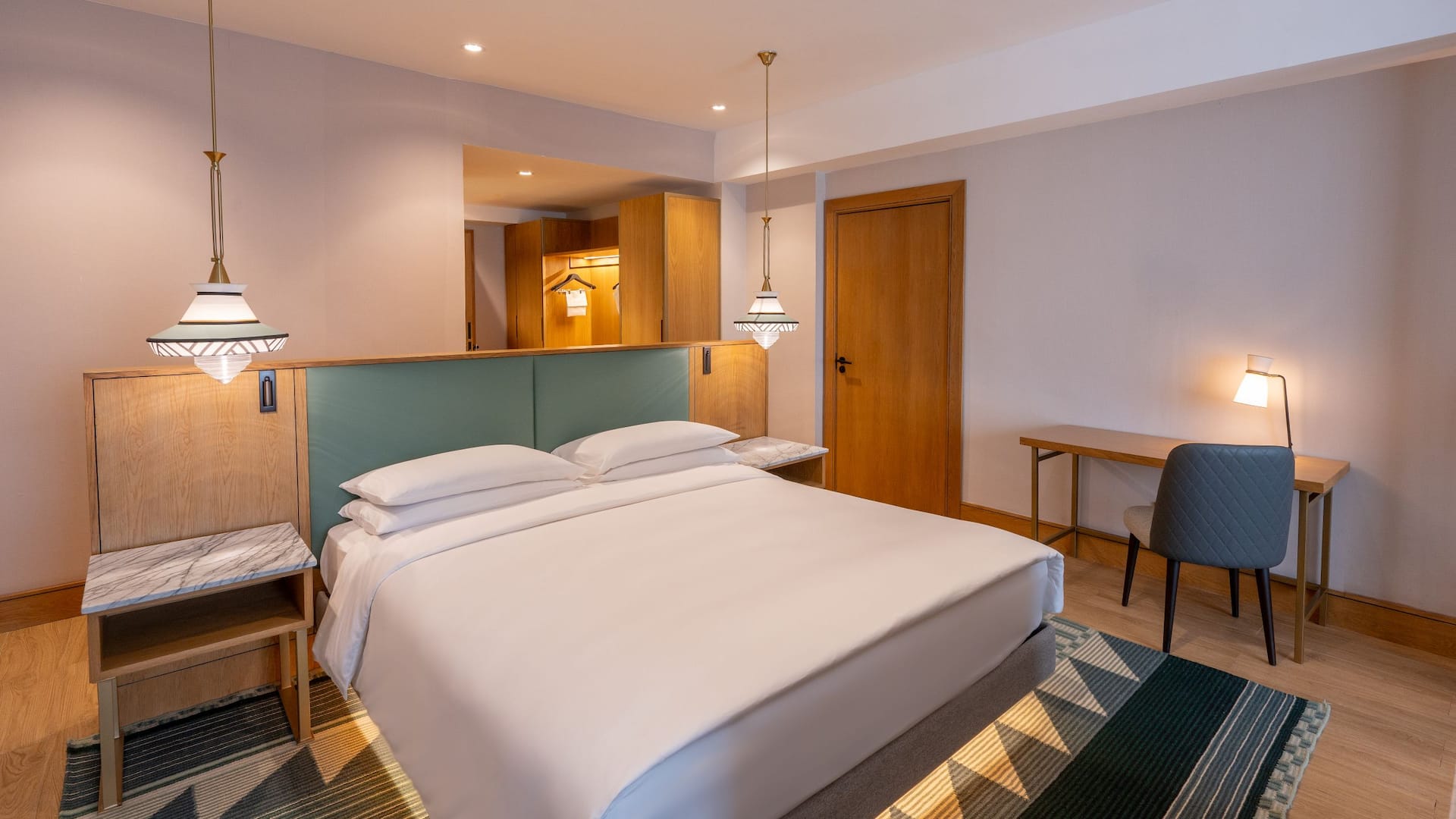 1/6 A modern deluxe room in Nairobi featuring a plush king-bed, elegant finishing and warm wooden accents for a comfortable stay that comes with access to the Regency club.