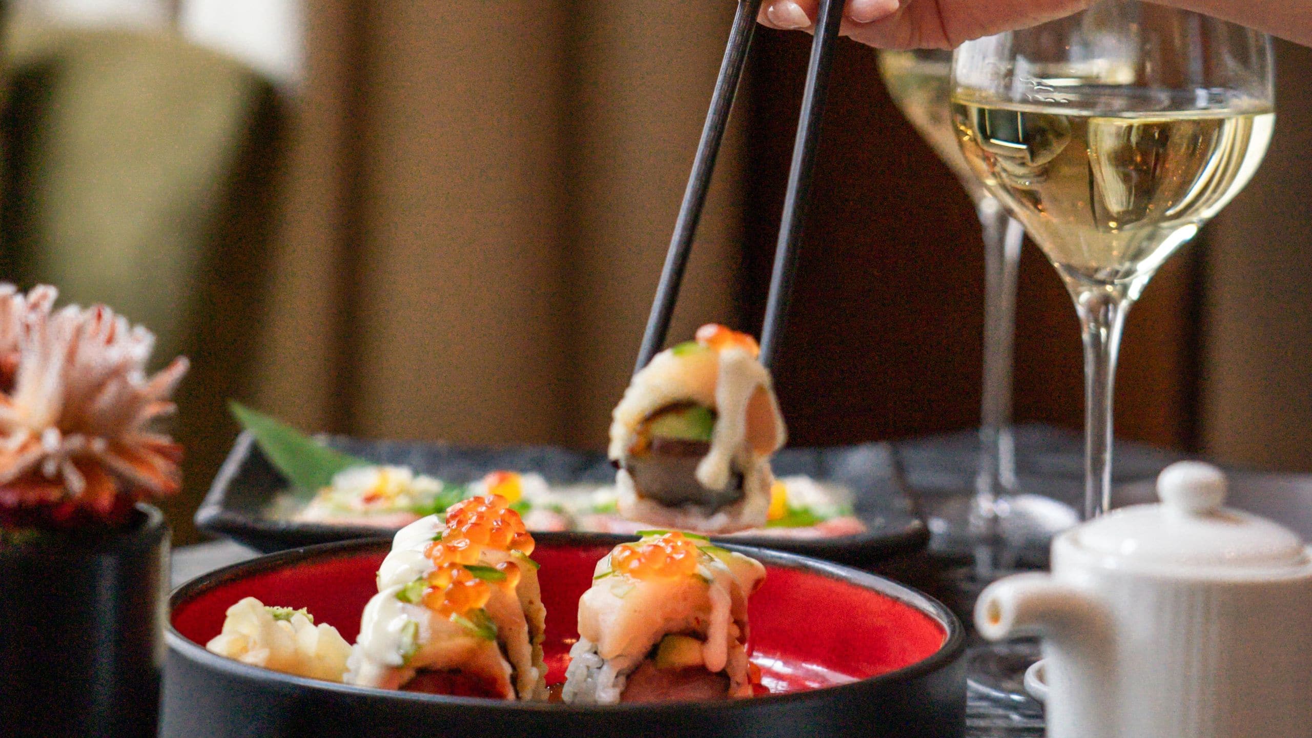 Park Hyatt Chicago Picking Up Nomi Sushi Roll With Chopsticks