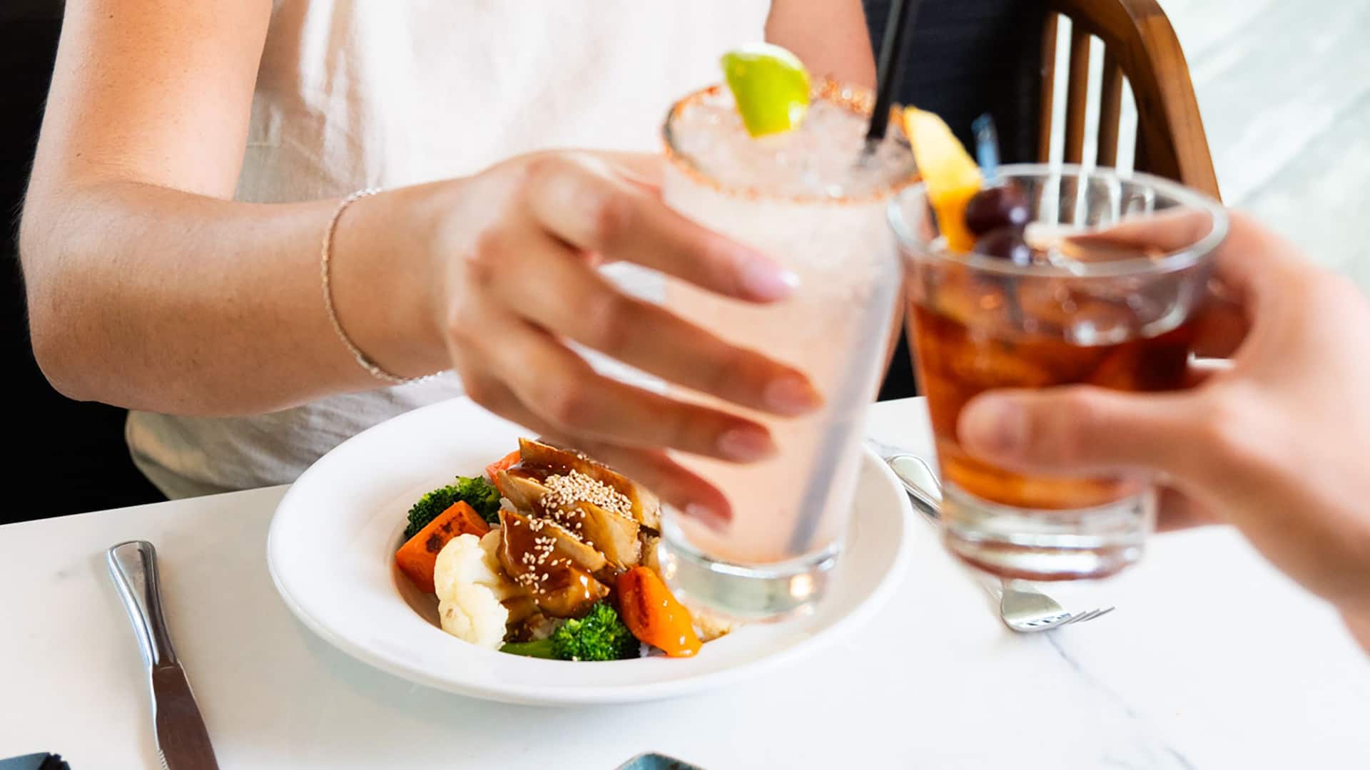 Hyatt Regency Long Beach Woman Cheers Cocktail