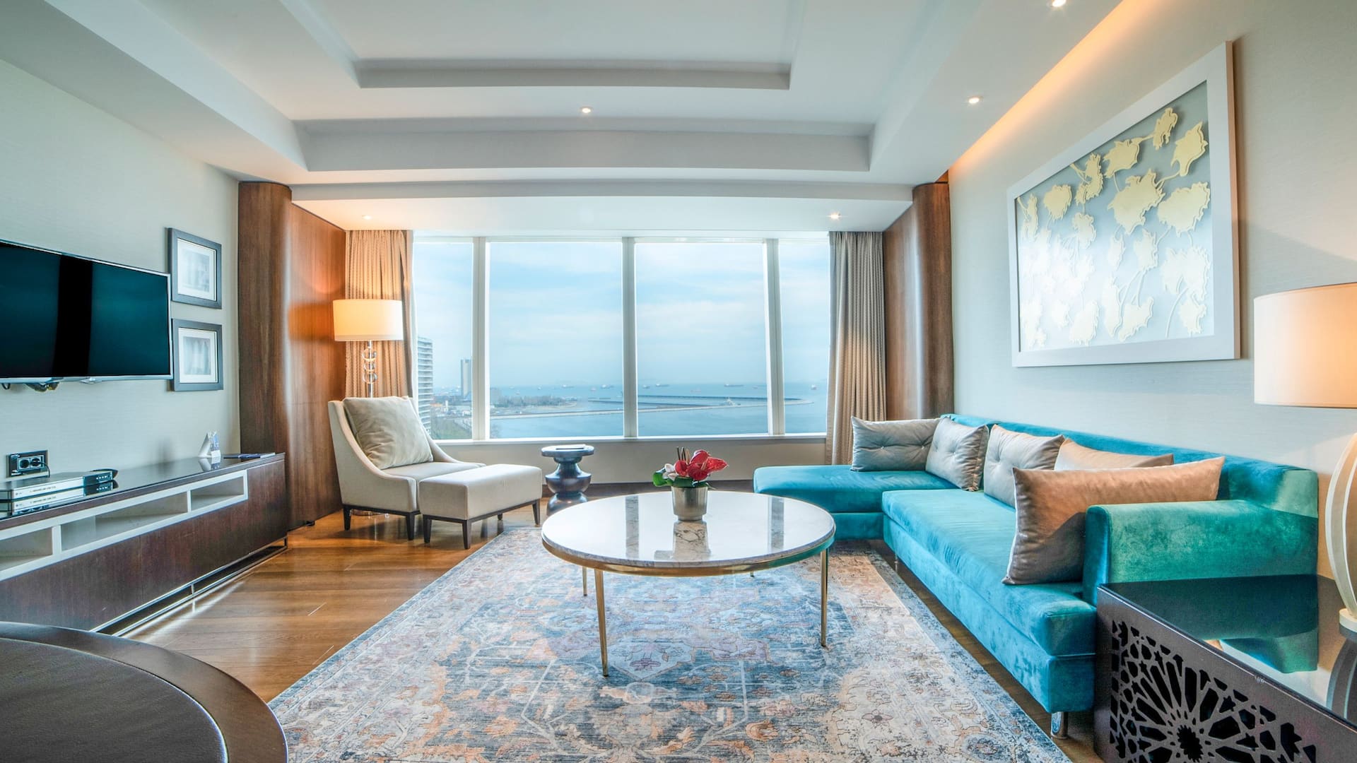 Spacious Regency Executive Suite at Hyatt Regency Istanbul Ataköy featuring panoramic sea views through floor-to-ceiling windows, a modern living area with plush seating, and contemporary décor for a refined stay.