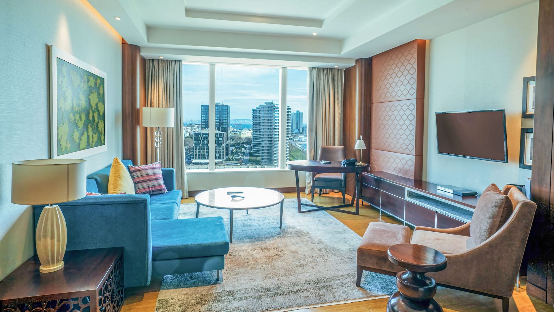 Regency Suite King at Hyatt Regency Istanbul Ataköy with plush seating, large windows overlooking the city, and modern décor.