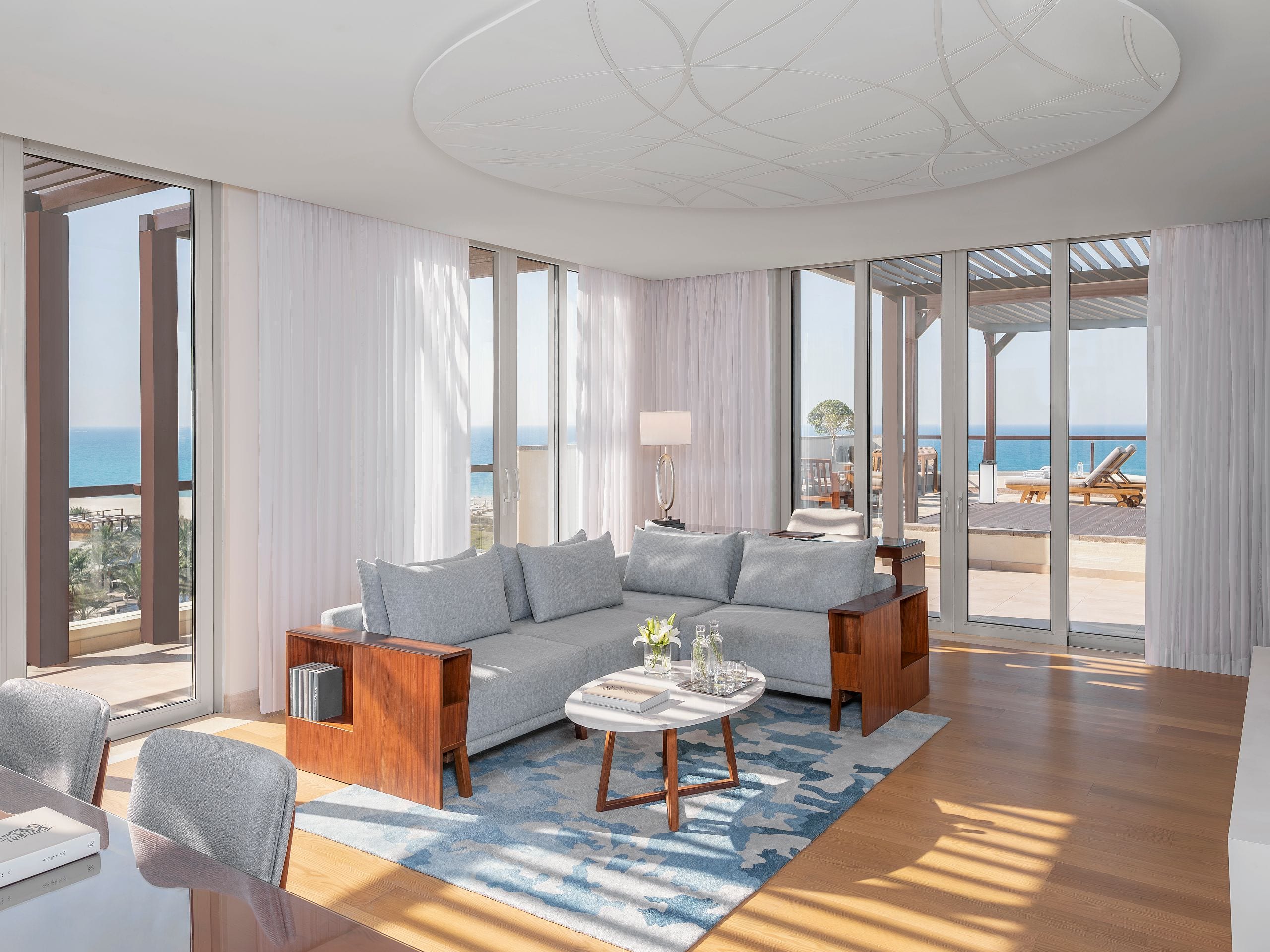 Park Hyatt Abu Dhabi Hotel and Villas - Lounge above the sea in a top-floor suite with a vast terrace, elegant living area, and sunlit luxury.