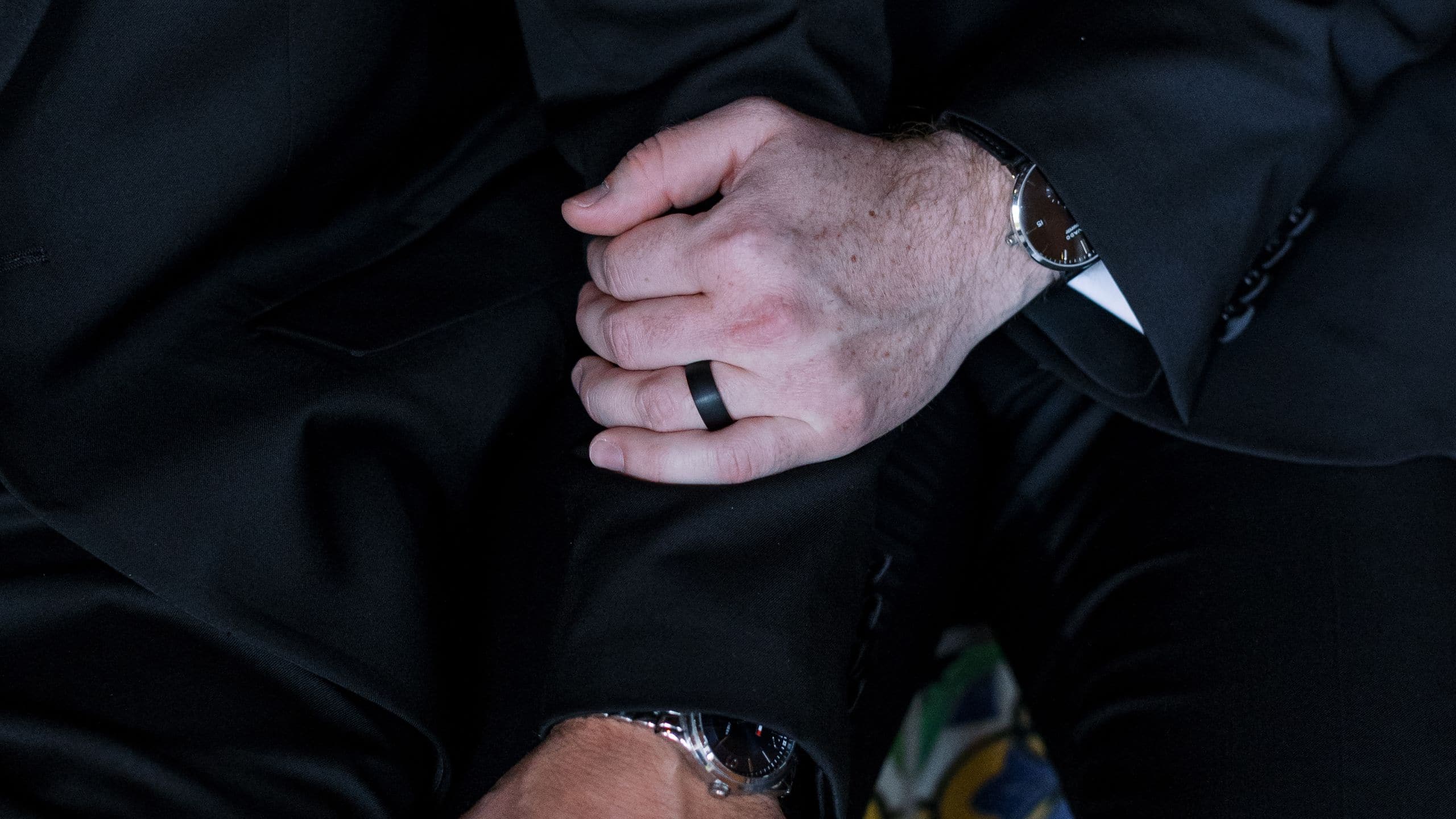 Royal Palms Resort and Spa Grooms Embrace On Tile Bench