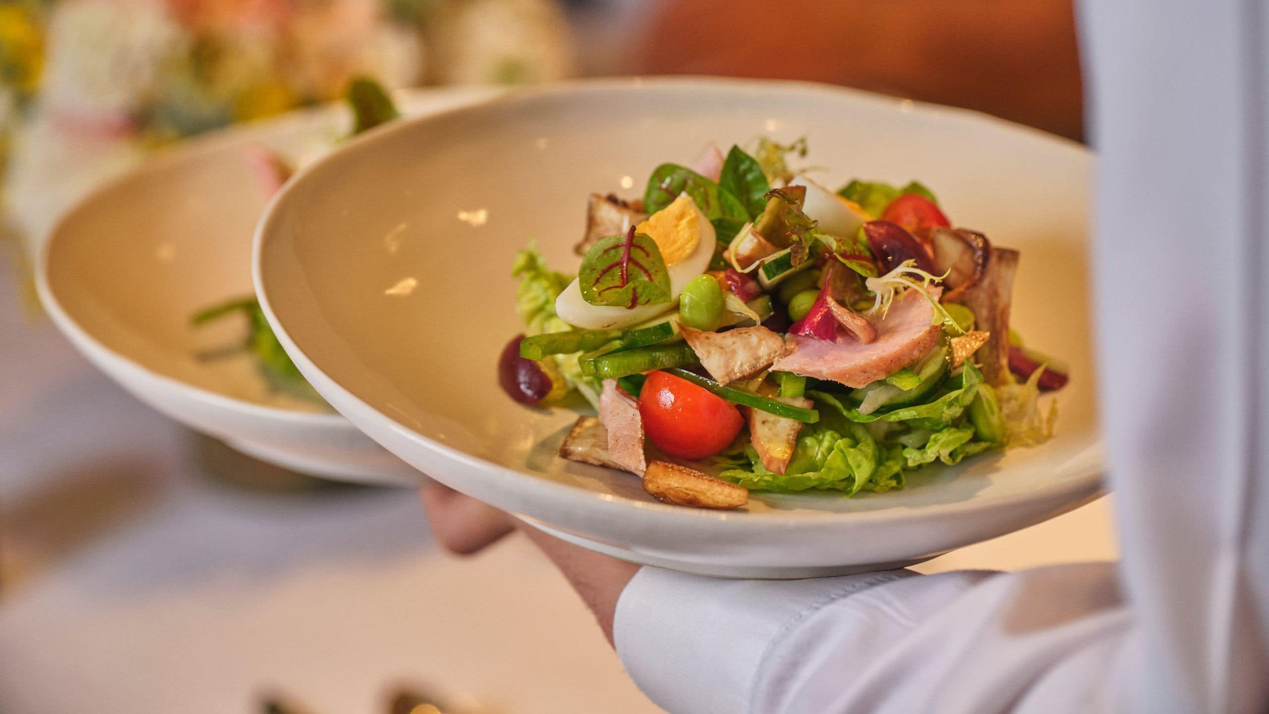 Global Chicken Caesar Salad Serving With Hand