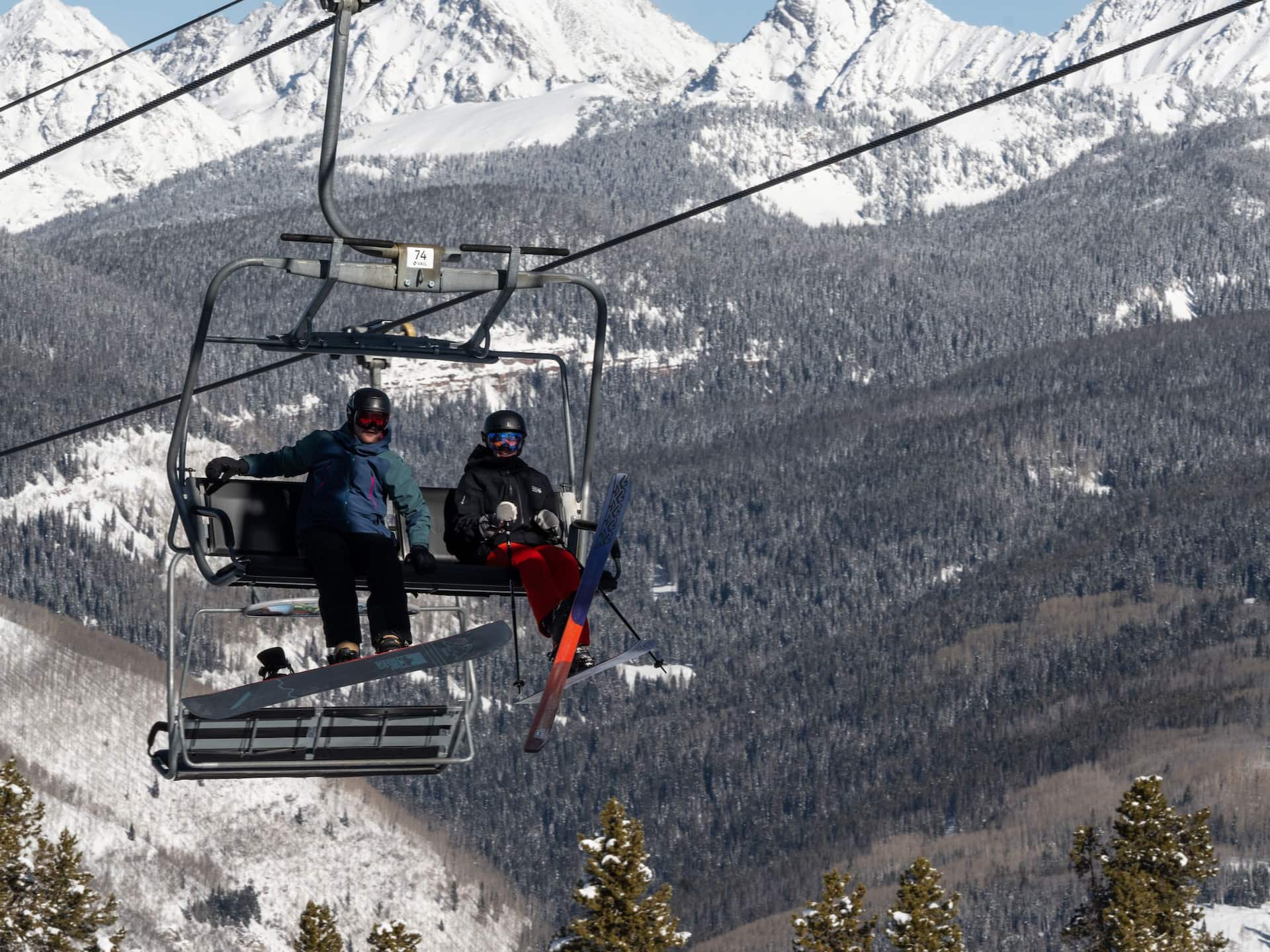 Grand Hyatt Vail Couple on Chairlift with Mountains in Background