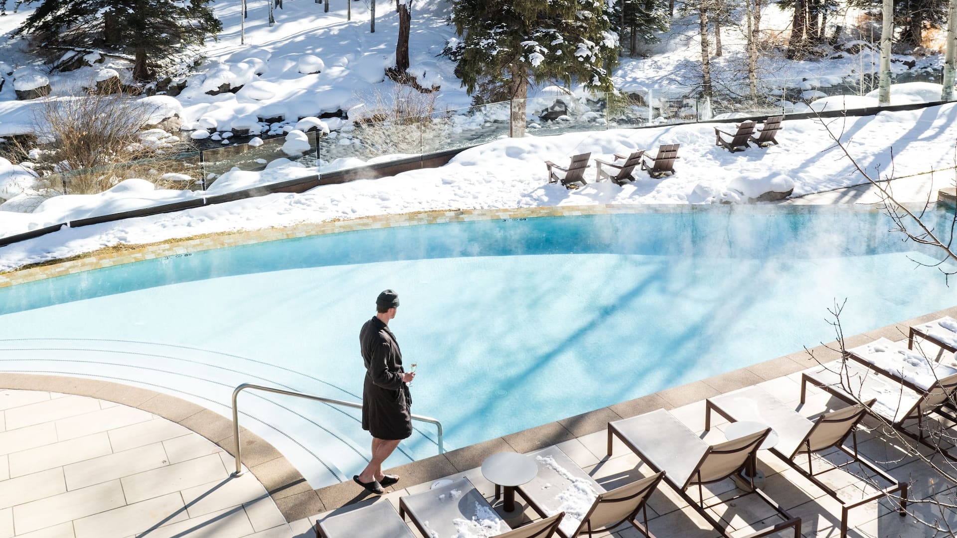 Grand Hyatt Vail Guest Walking Along Edge of Pool Winter