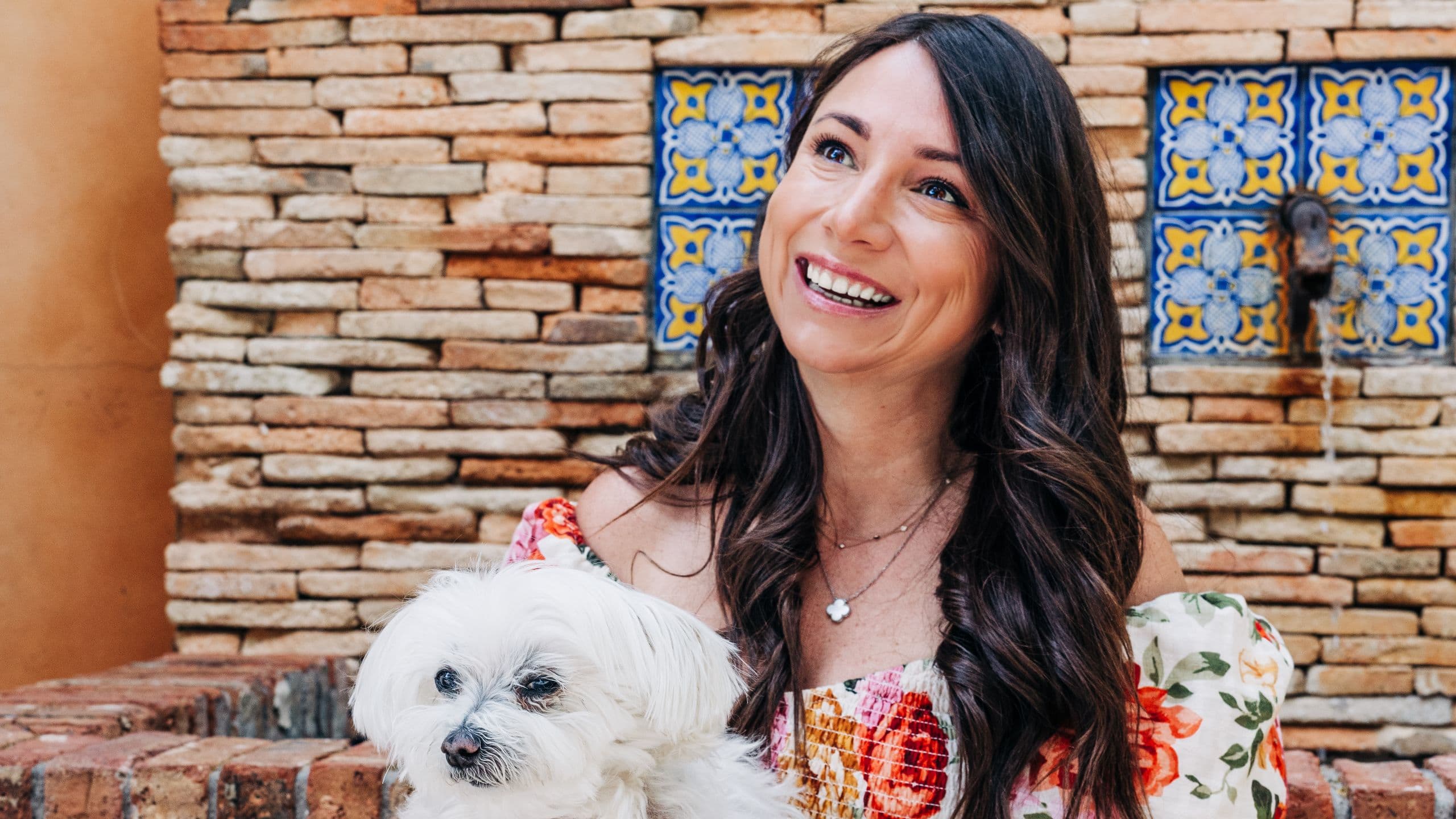 Royal Palms Resort and Spa Dog Photos With Guest Infront Of Water