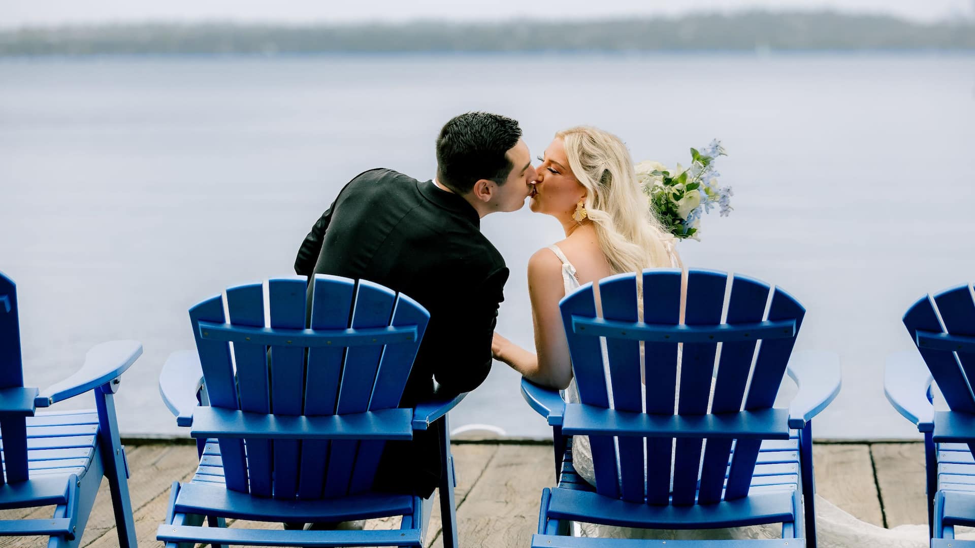 Hyatt Regency Lake Washington at Seattle's Southport Couple Kissing On Blue Chairs On Dock