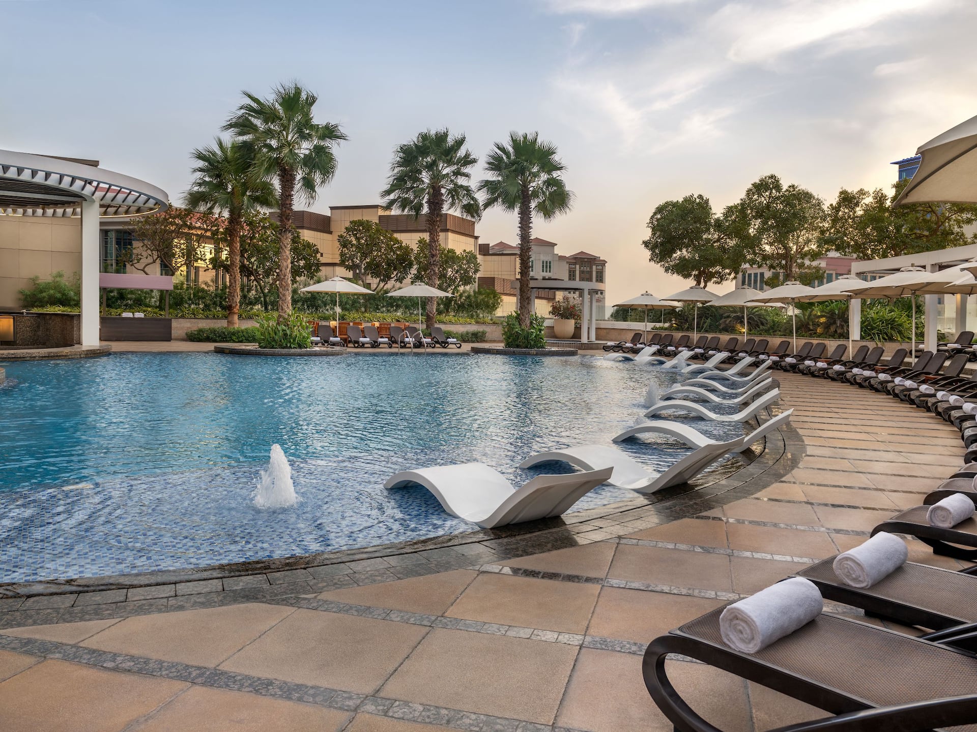 A view of outdoor swimming pool with a pool bar area at Hyatt Regency Dubai Creek Heights
