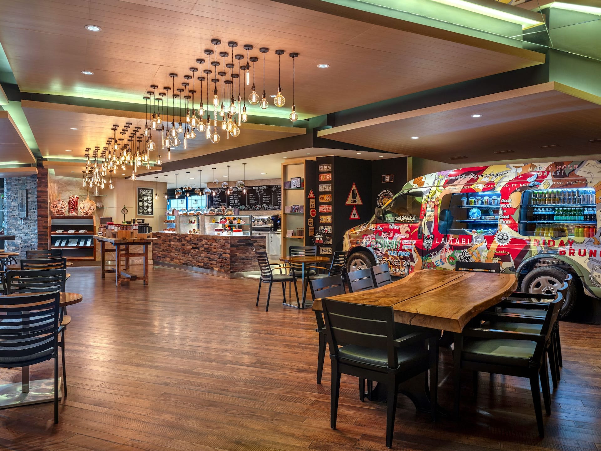 View of market24 restaurant at Hyatt Regency Dubai Creek Heights, with chef’s station and earthy-tone interior.