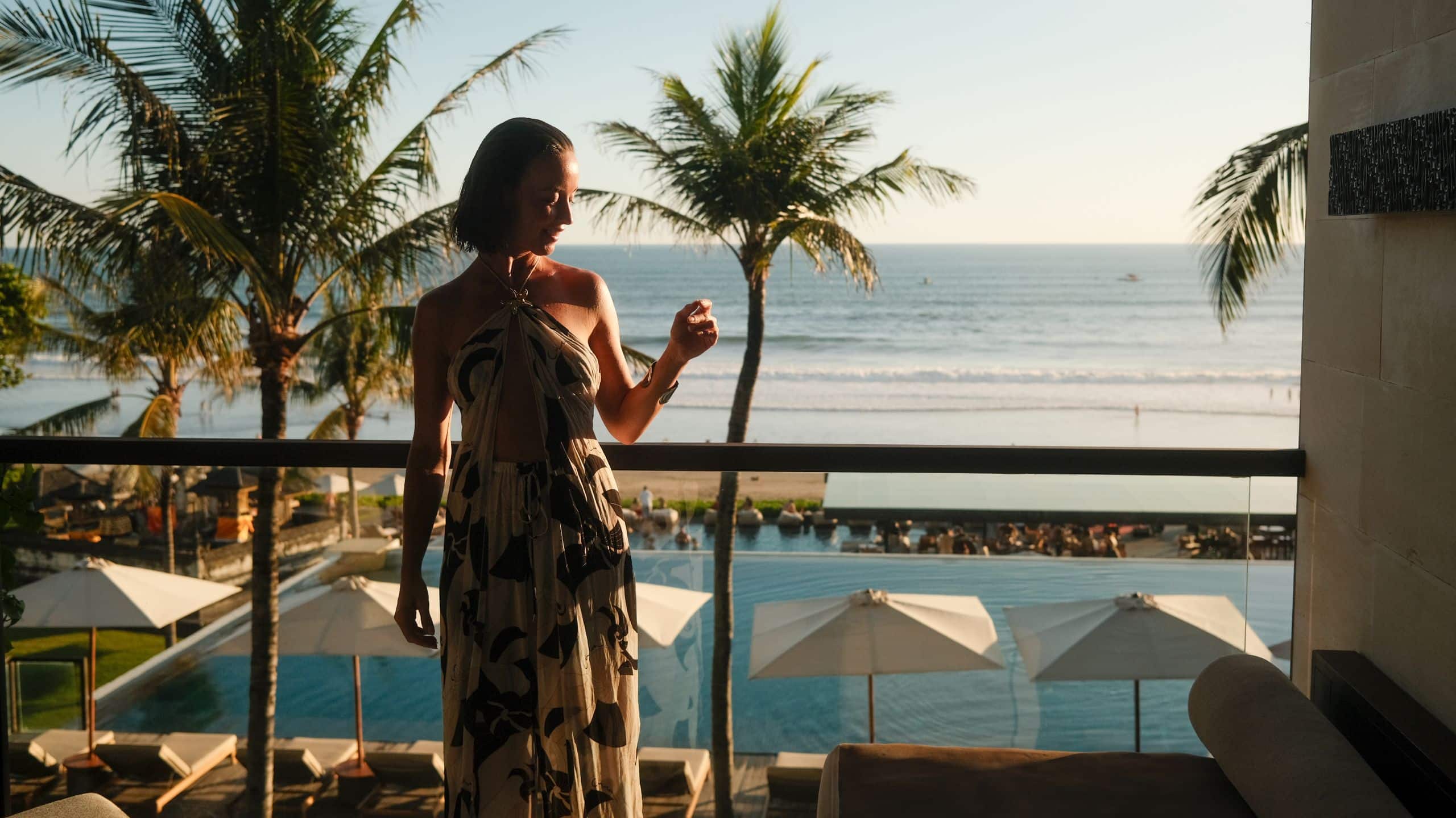 1 of 1 Alila Seminyak Woman Having A Drink On The Balcony
