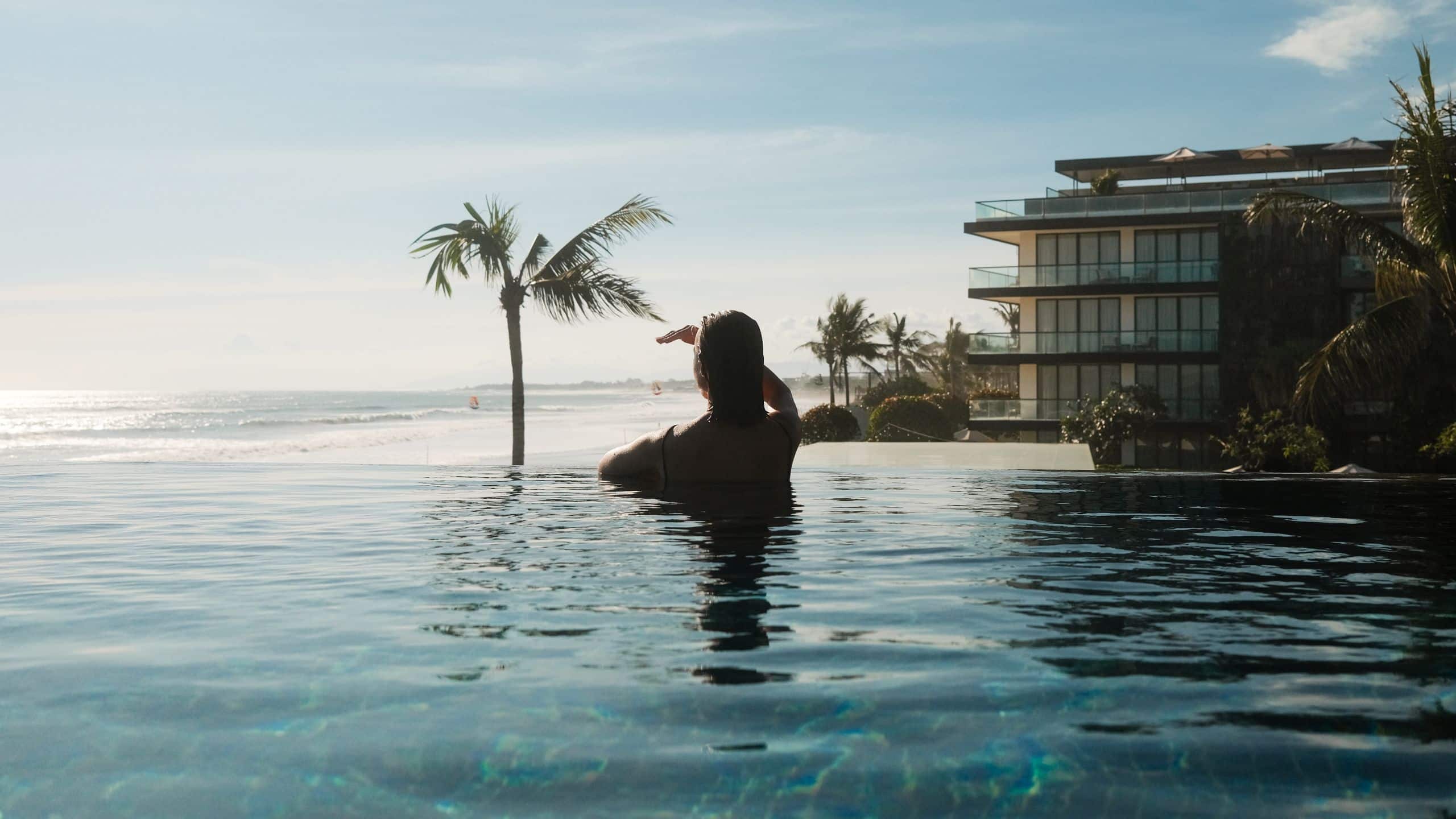 Alila Seminyak Woman Swimming Infinity Pool