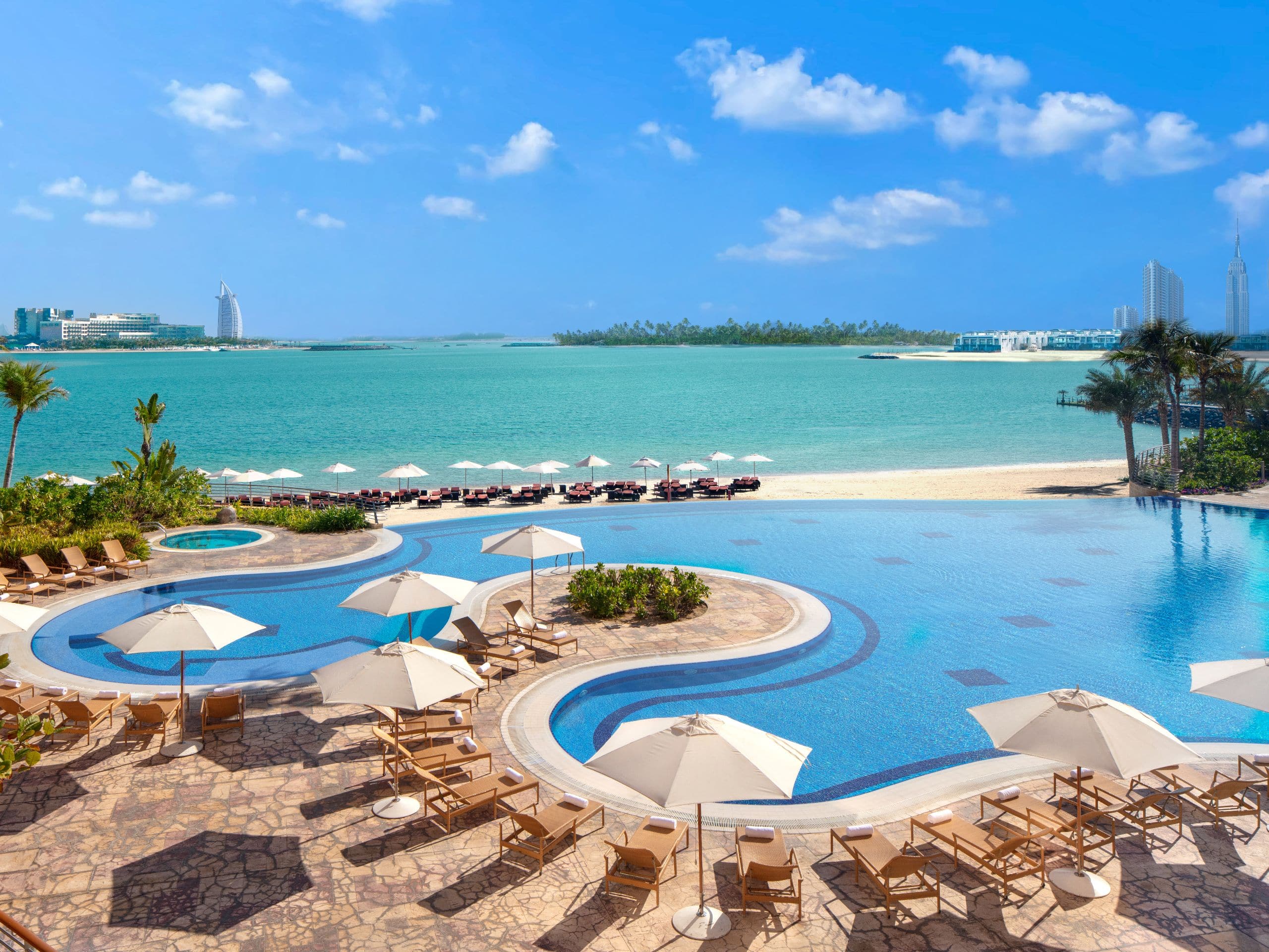 Outdoor Pool at Andaz Dubai The Palm, with access to private beach, overlooking Arabian Gulf and Dubai skyline.