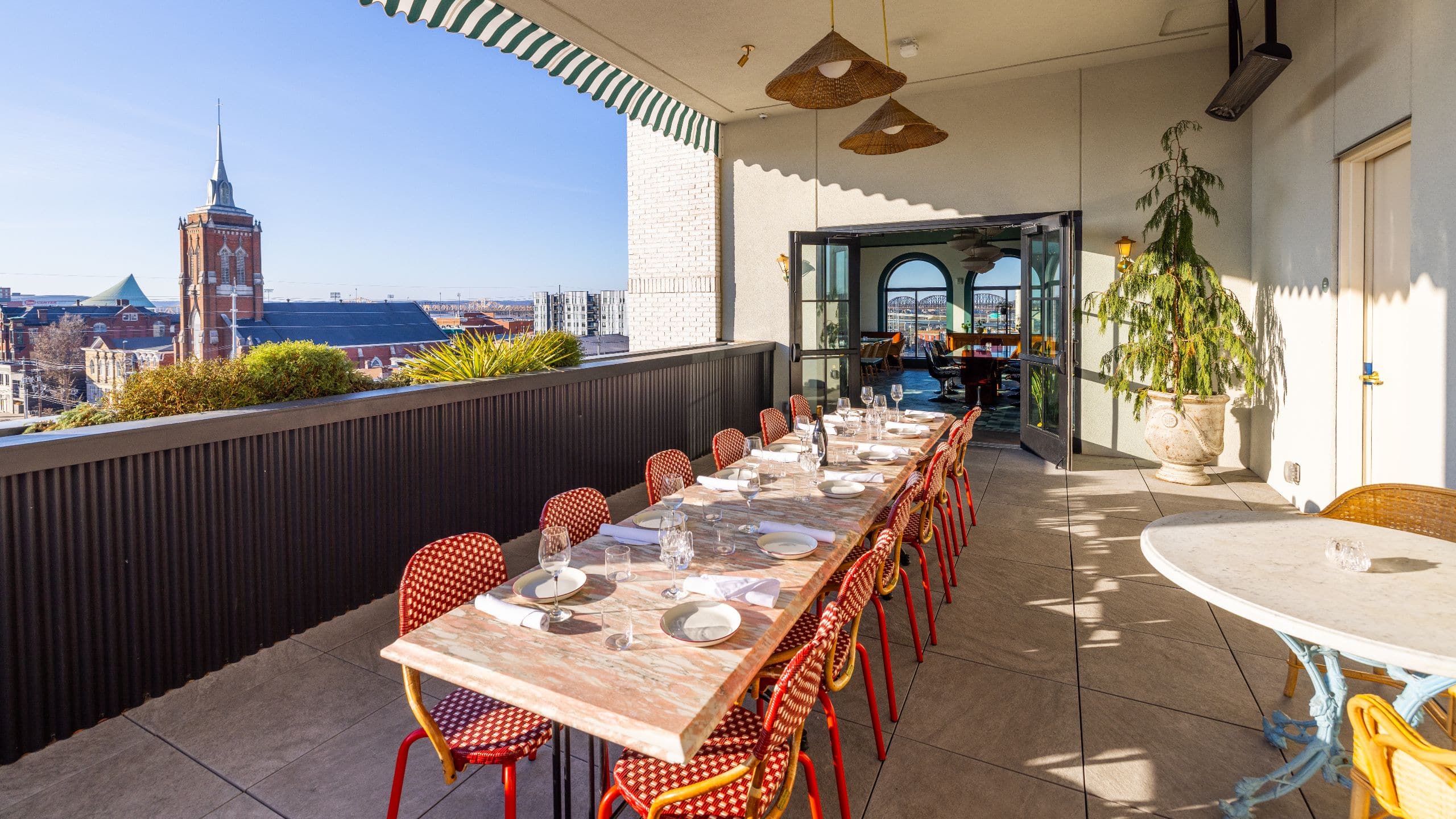 Hotel Genevieve, Bunkhouse Hotels Patio Event Set Up With Red Chairs