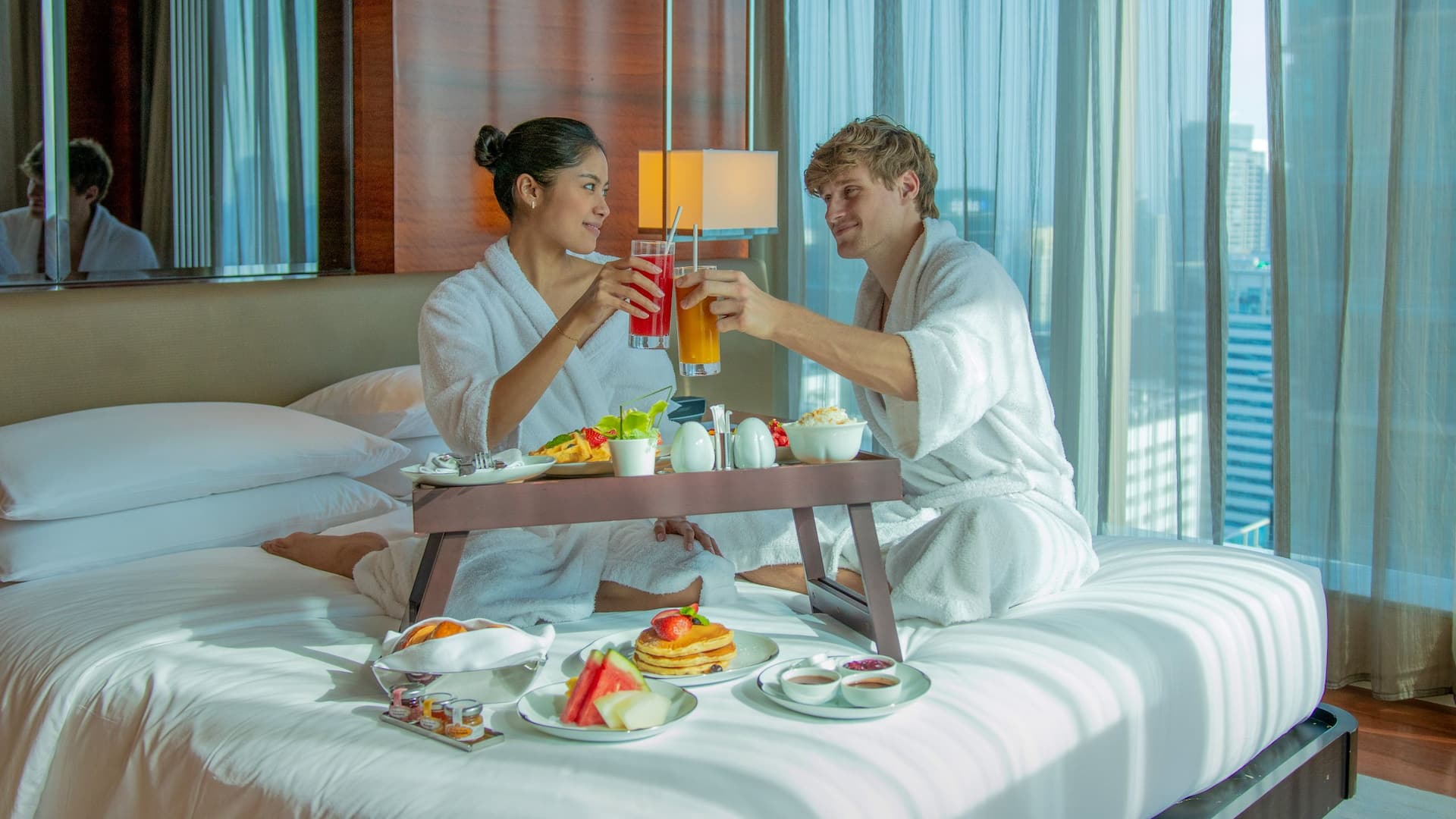 1 of 1 Grand Hyatt Manila In Room Dining Shot Couple Toasting In Bed