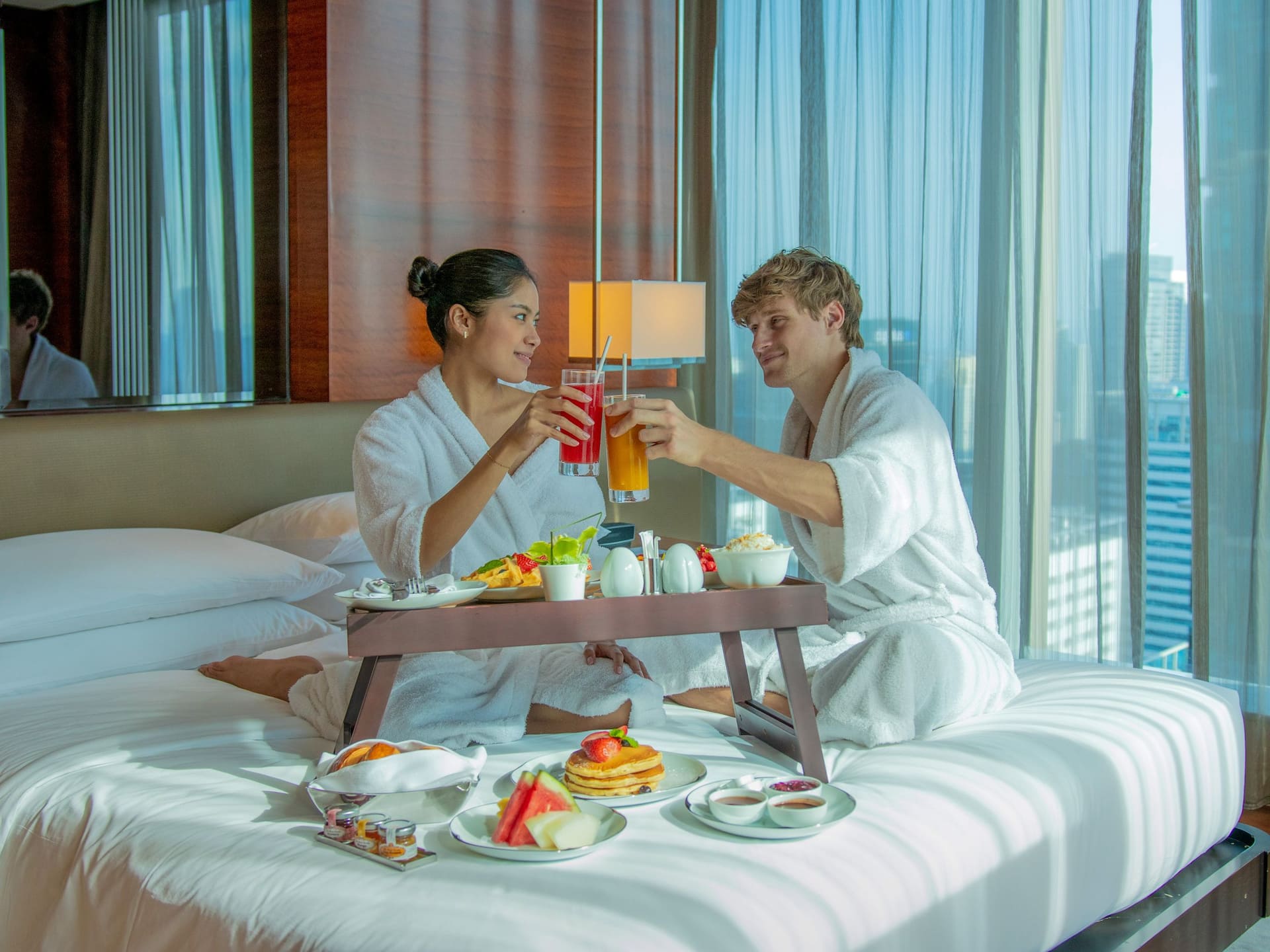 Grand Hyatt Manila In Room Dining Shot Couple Toasting In Bed