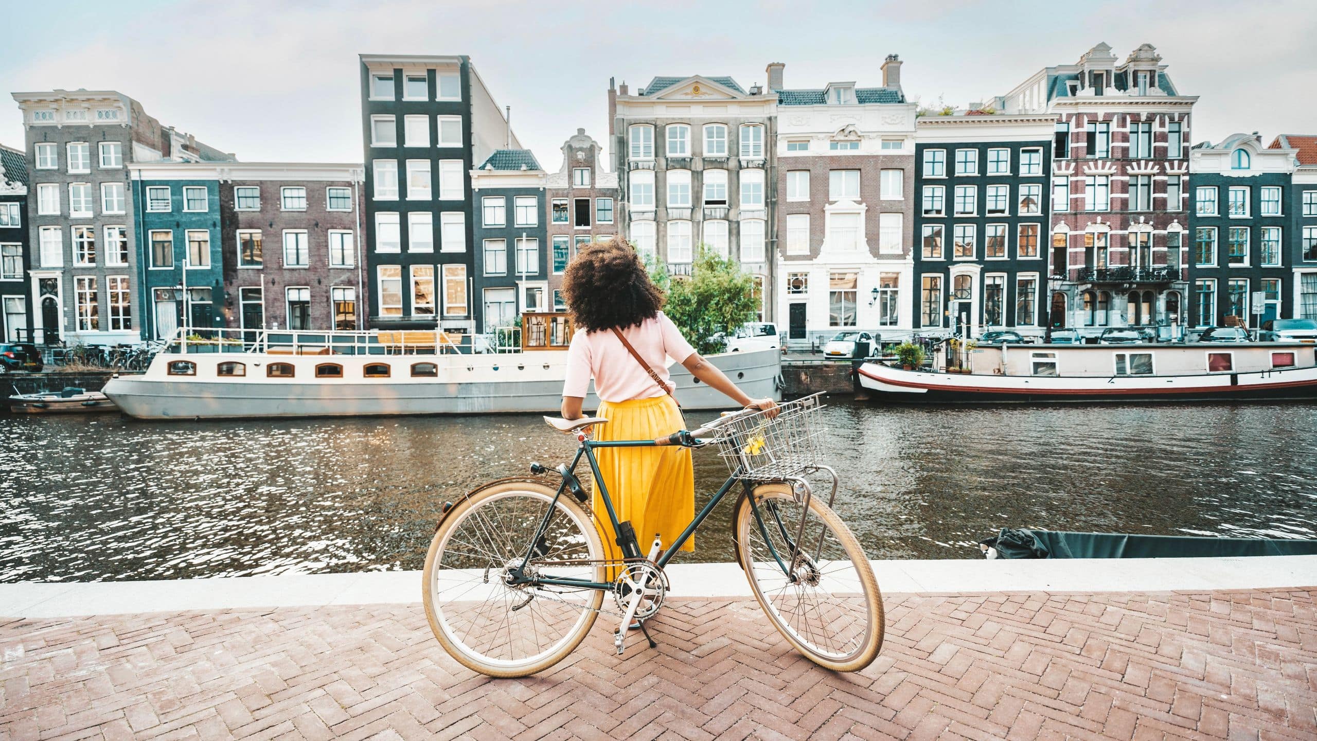 Woman Biking Near Canal