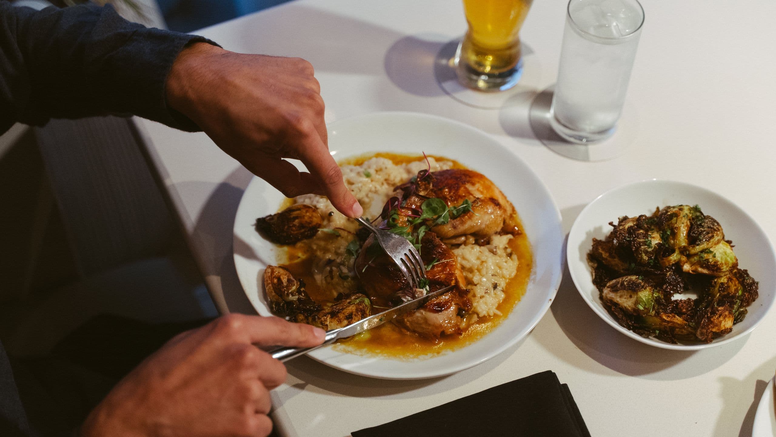 Hyatt Centric Delfina Santa Monica Man Cutting Roasted Chicken
