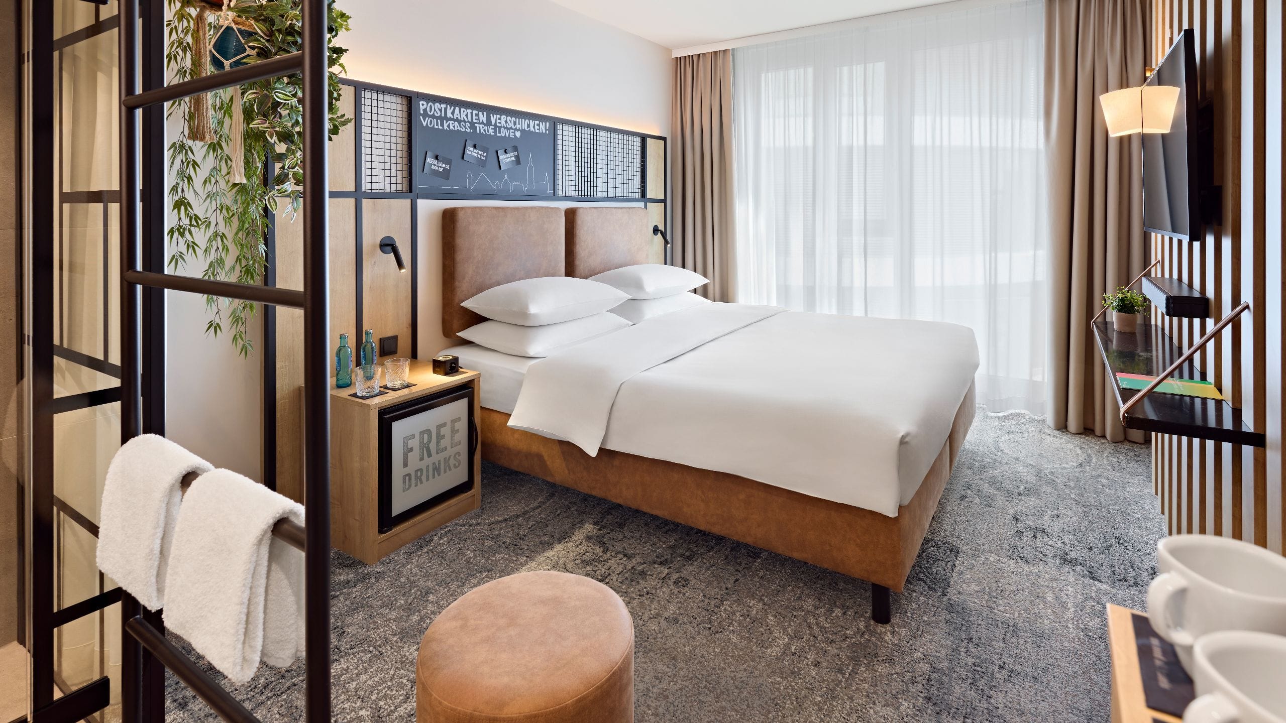 1 of 5 Modernly furnished room with a king-size bed and stylish atmosphere at Me and All Hotel Ulm.
