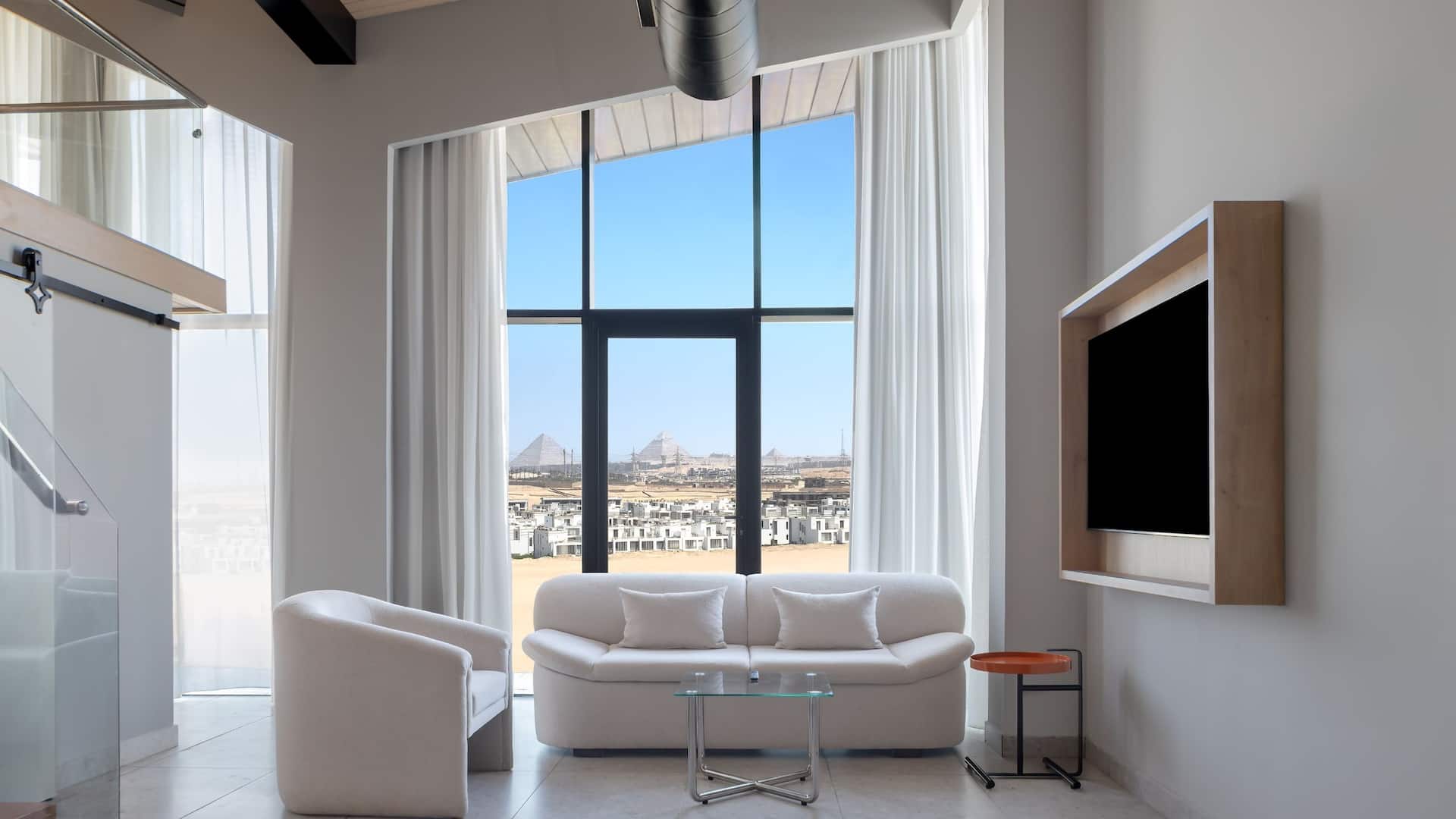3 of 6 Hyatt Centric Cairo West Premium Loft Suite Pyramids View Seating Area Tv